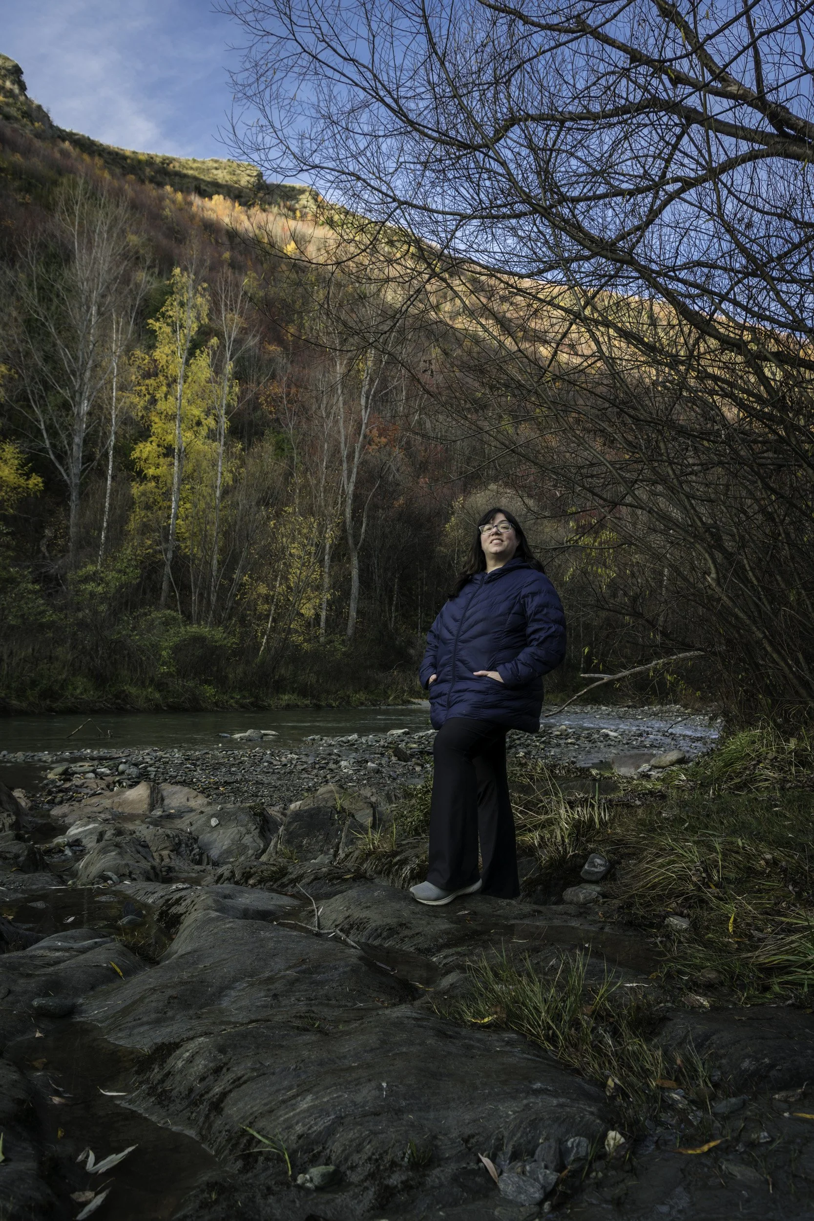 Female traveller enjoying the scenery along the Arrowtown River, professionally photographed
