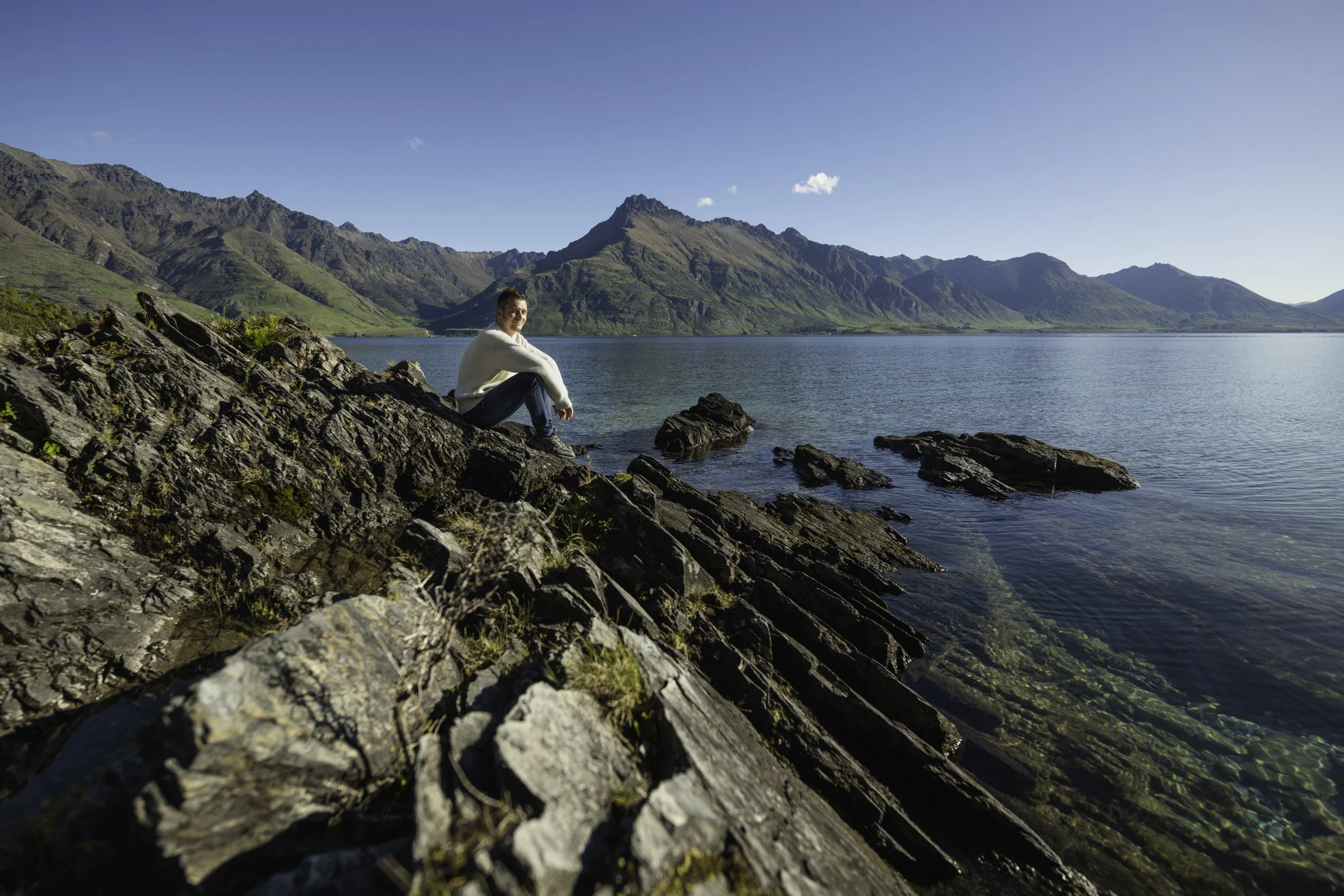 Solo traveller enjoying the views of Lake Whakatipu, professionally photographed on a guided tour