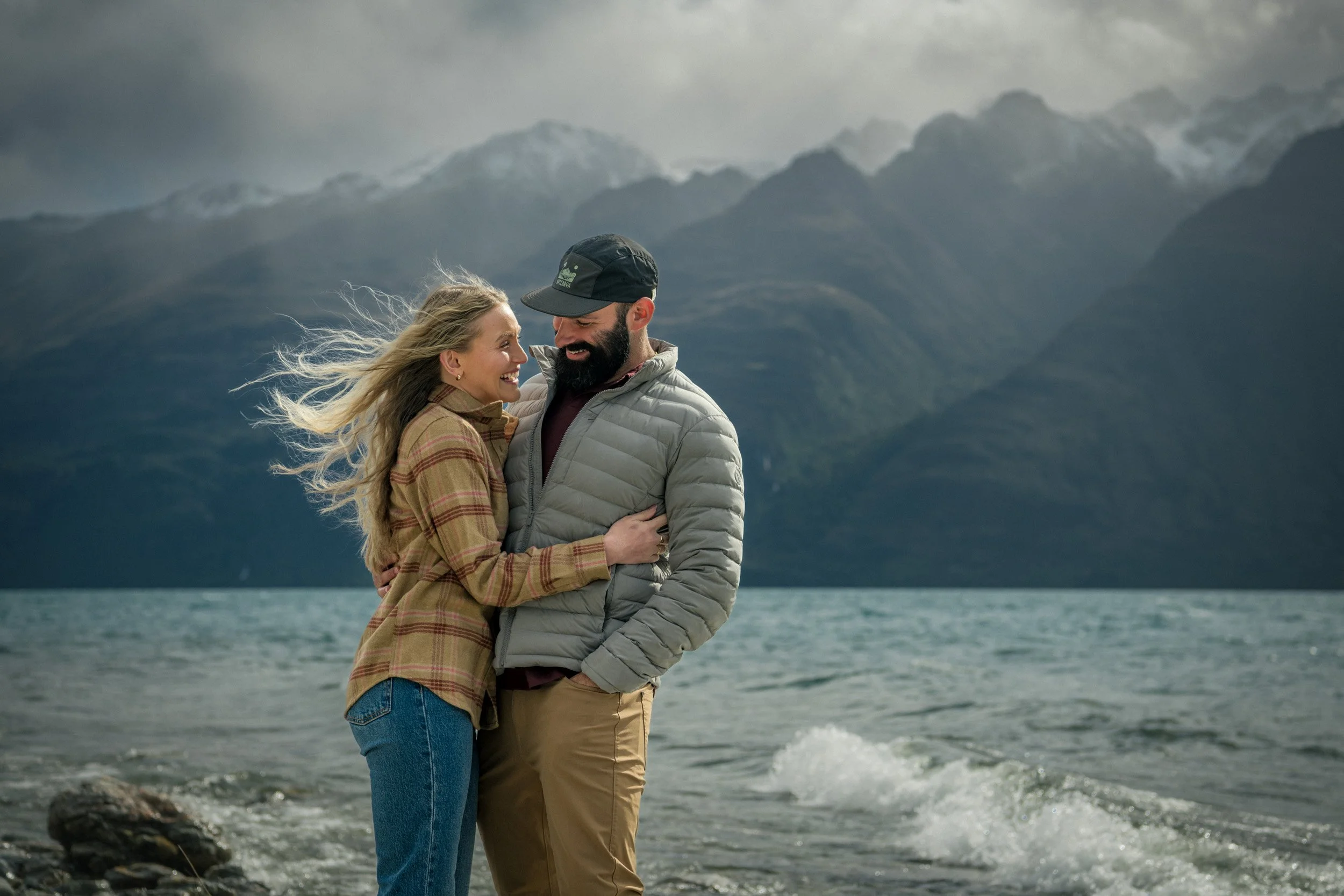 Couple laughing during adventure with camera capturing candid moments