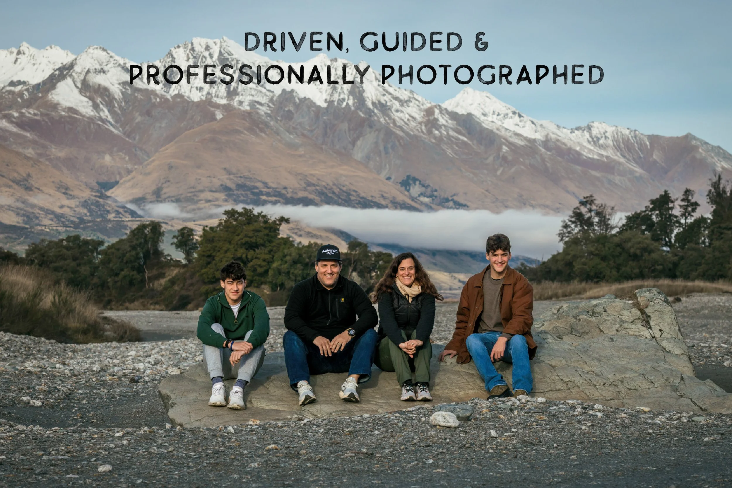 American family sitting on a rock next the Dart River
