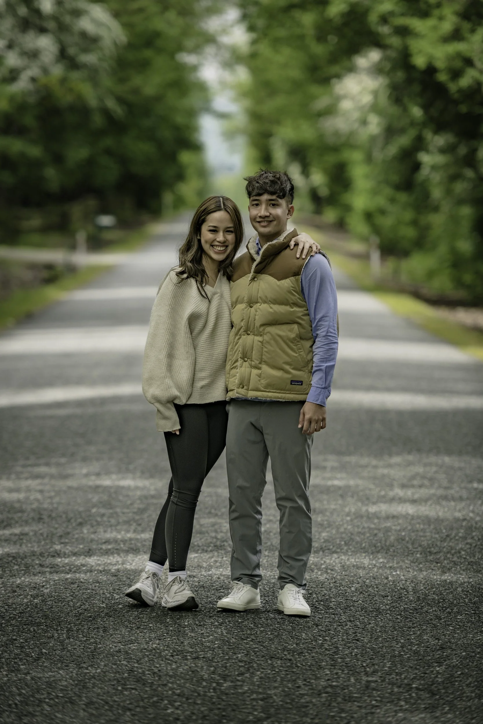 Young couple having a pre-wedding photoshoot on a Queenstown backcountry road, professionally photographed