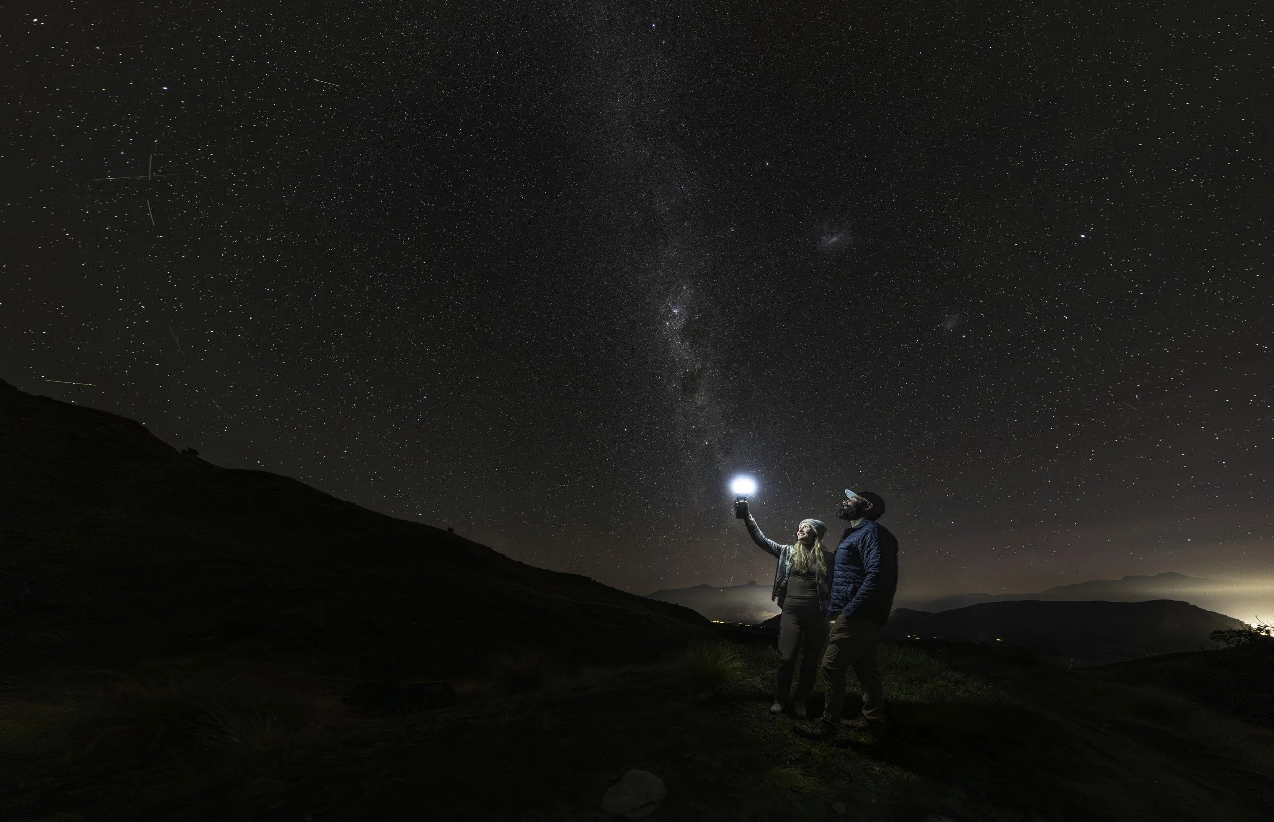 Guests enjoying the pristine night sky above Queenstown - professional photographed by LPSNZ photographer Simon Williams - Owner / Operator of authenticAs