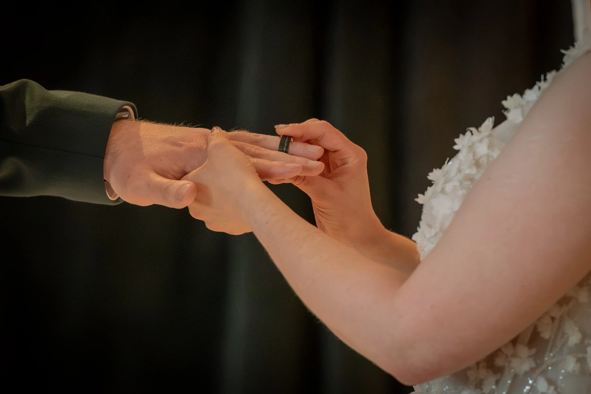 Close-up of wedding ring being placed during Queenstown wedding ceremony