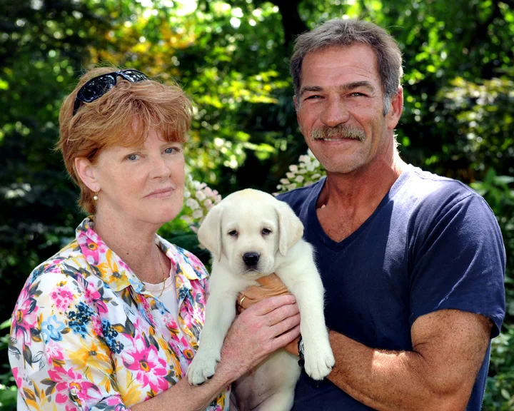 West is shown here with her husband and their yellow lab.