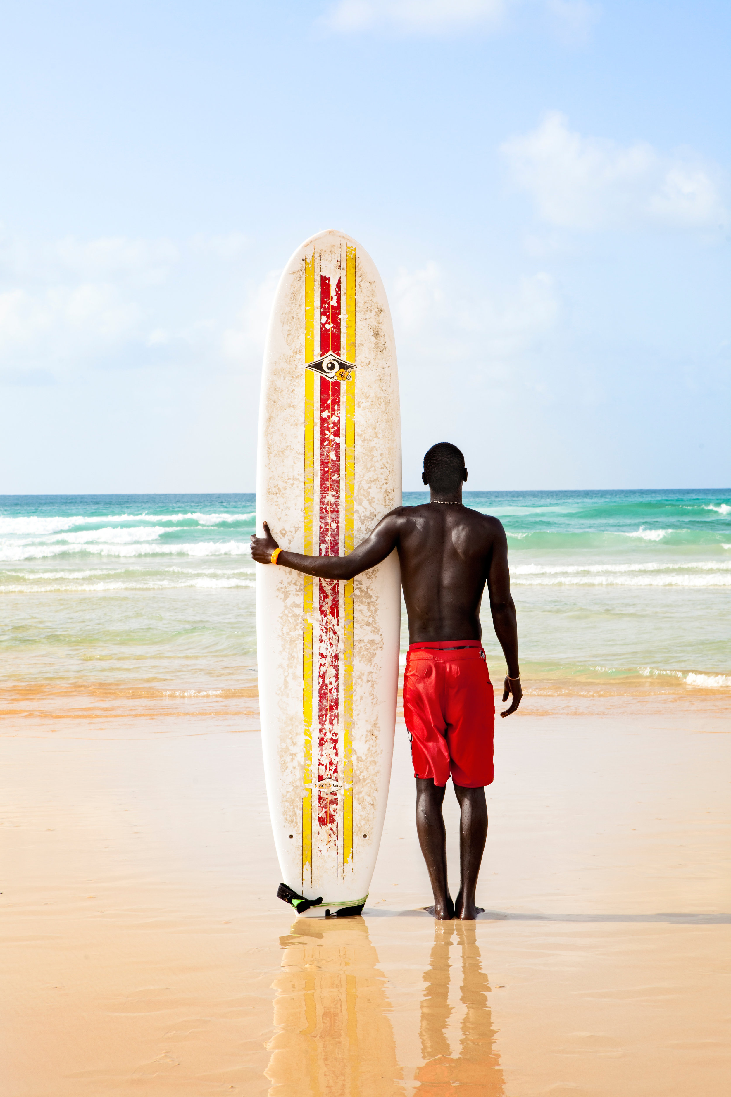 Man with surfboard, Yoff beach, Dakar, Senegal.jpeg