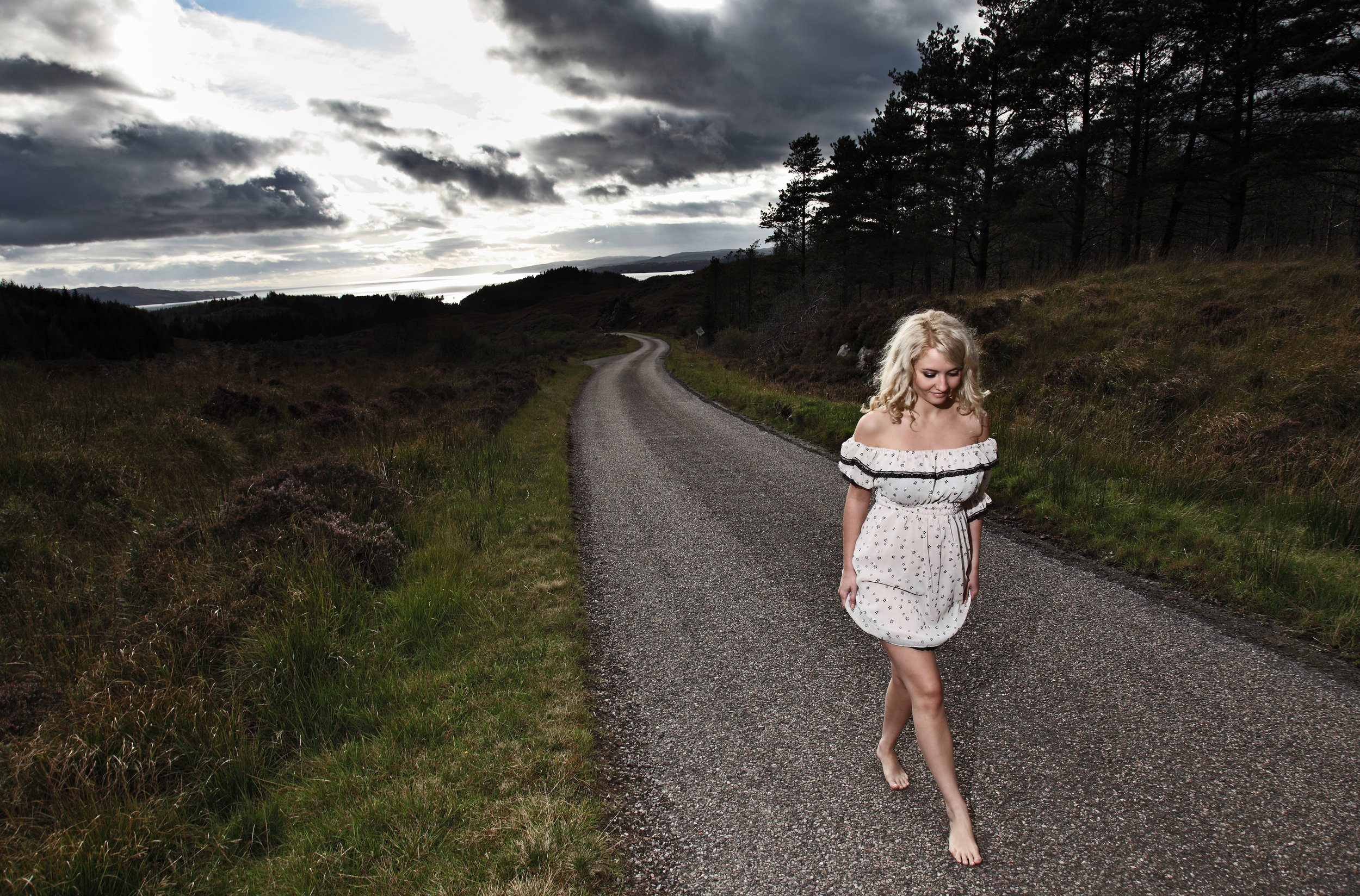 Woman walking along a road in the Scottish Highlands.jpg