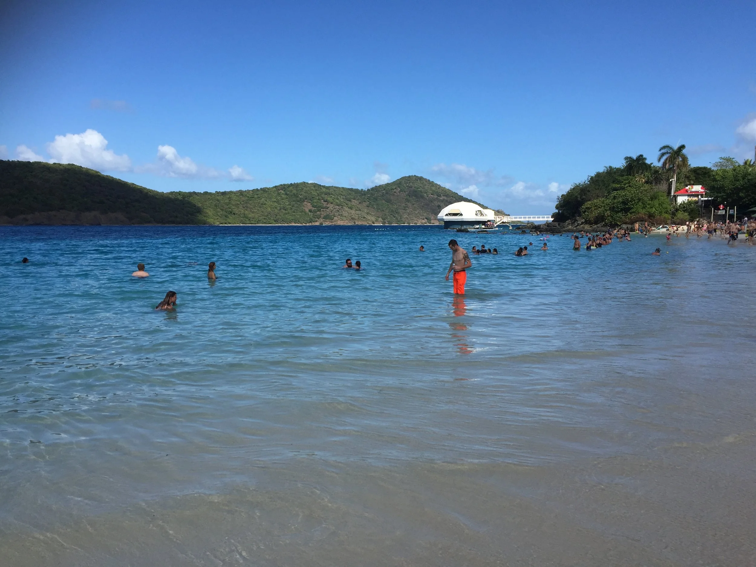 A view of Coki Beach with Coral World Ocean Park in the background