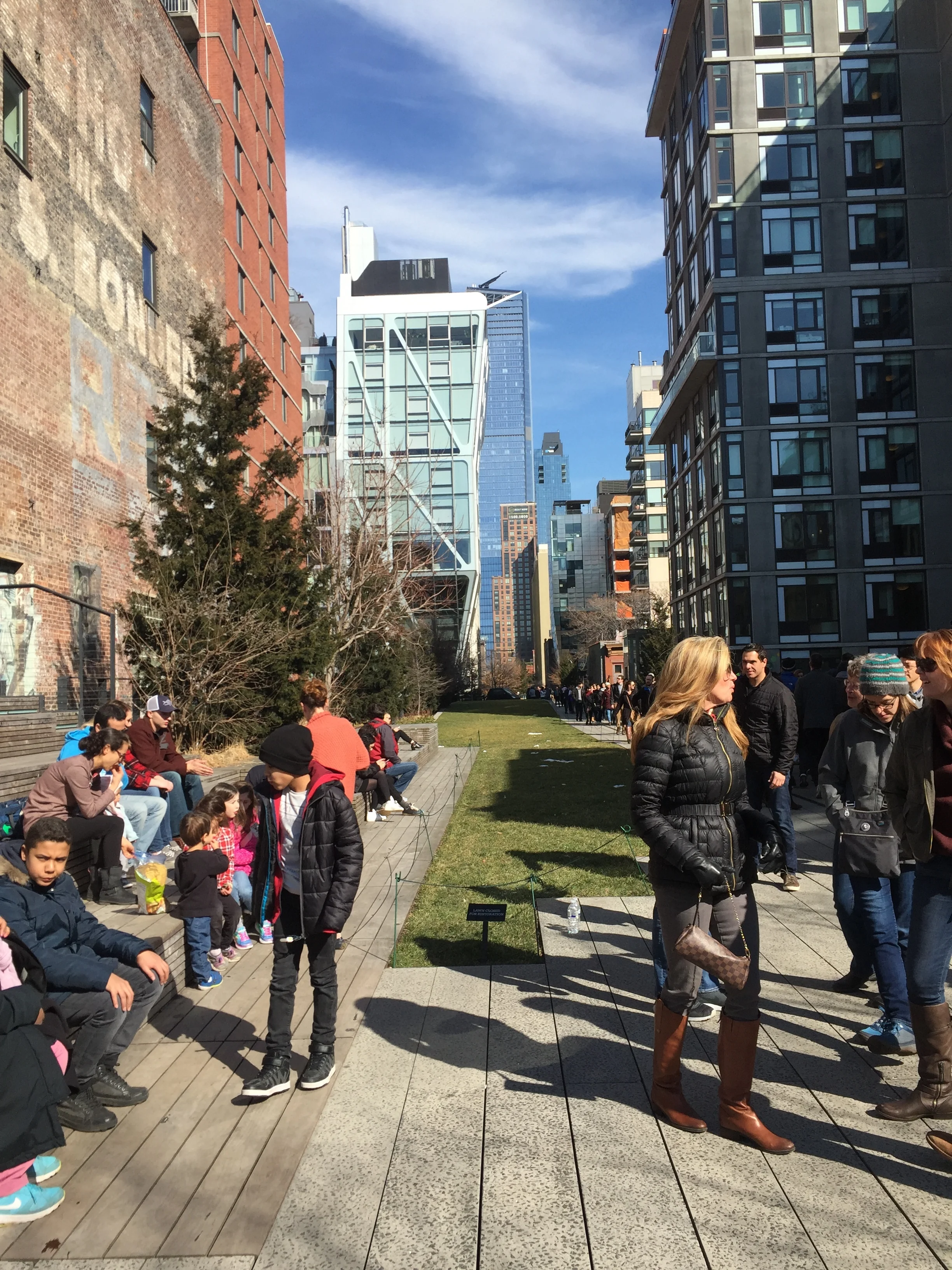 Walking between buildings in High Line Park.