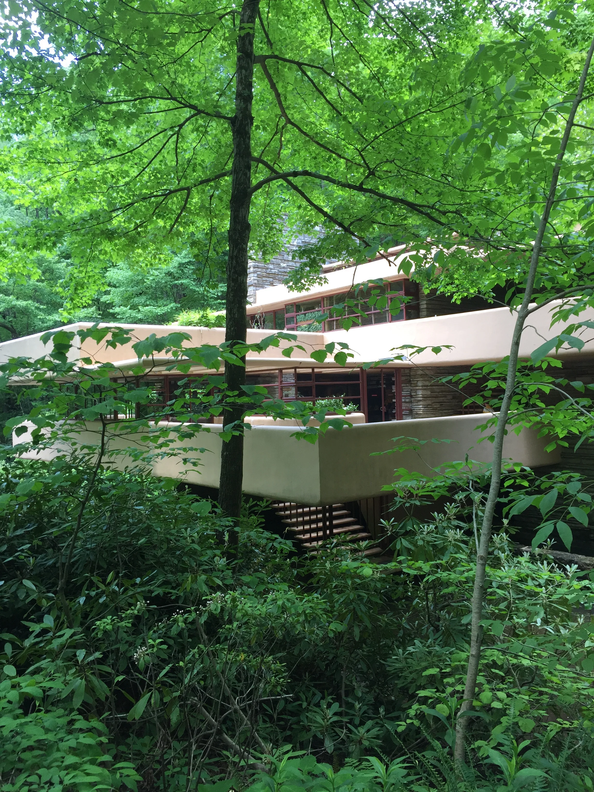 Each bedroom and the living room has its own private terrace, adding to the blending of nature and building. Wright used natural paint colors for the cement and the steel to keep with oneness with nature.