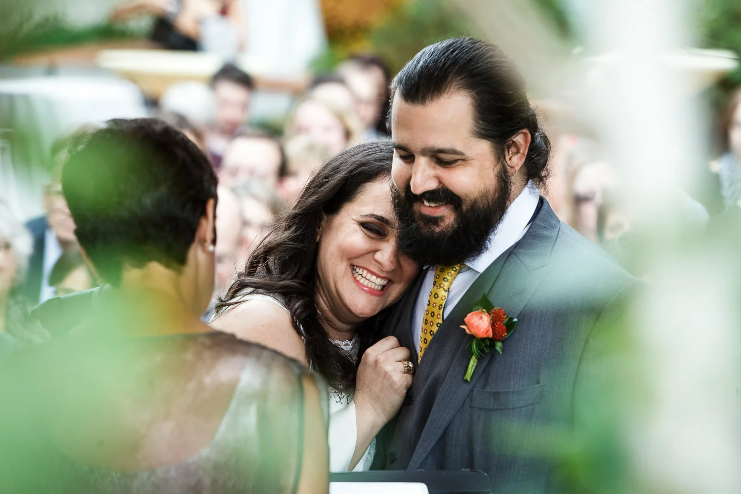 bride leans on the grooms shoulder during the ceremony at Greenhouse Loft in Chicago