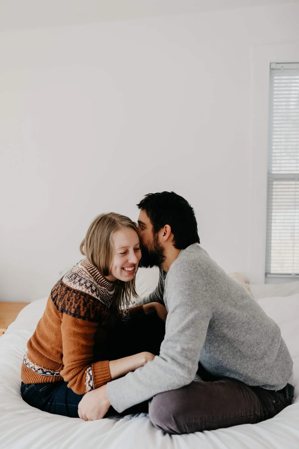 Michigan couple sitting on their bed