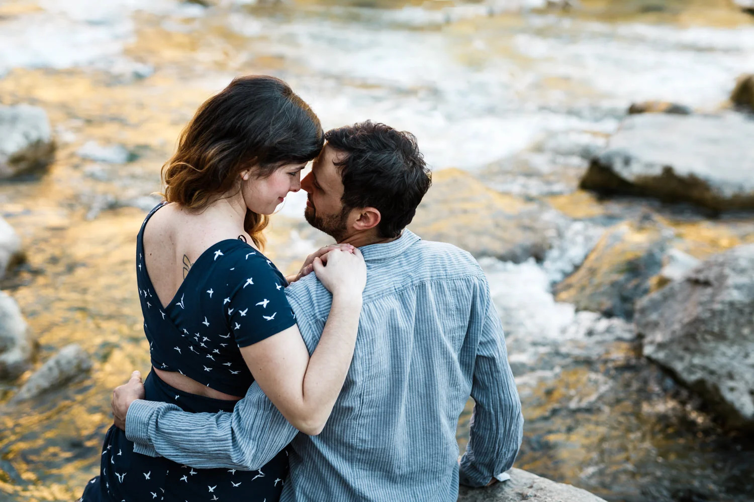 engaged couple hugging in Austin's greenbelt park