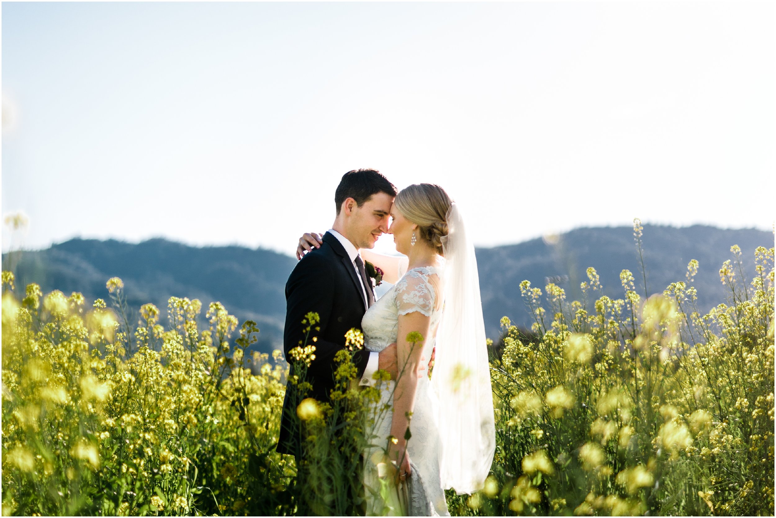 bride and groom posing in a field of flowers in Napa Valley