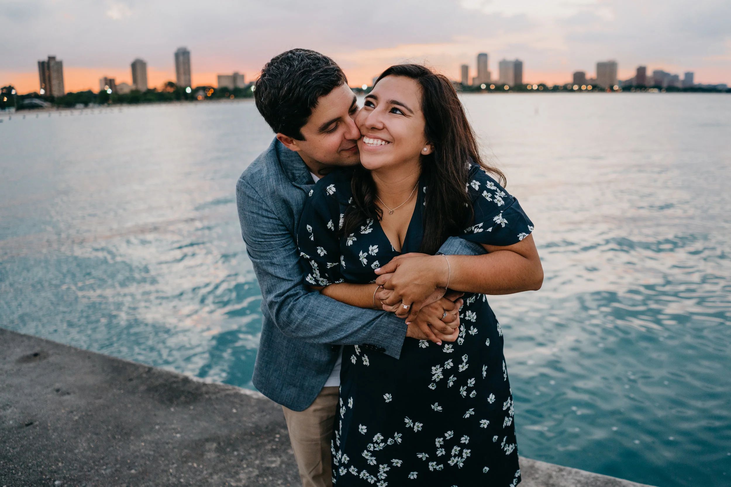 engaged couple embracing at North Avenue Beach in Chicago