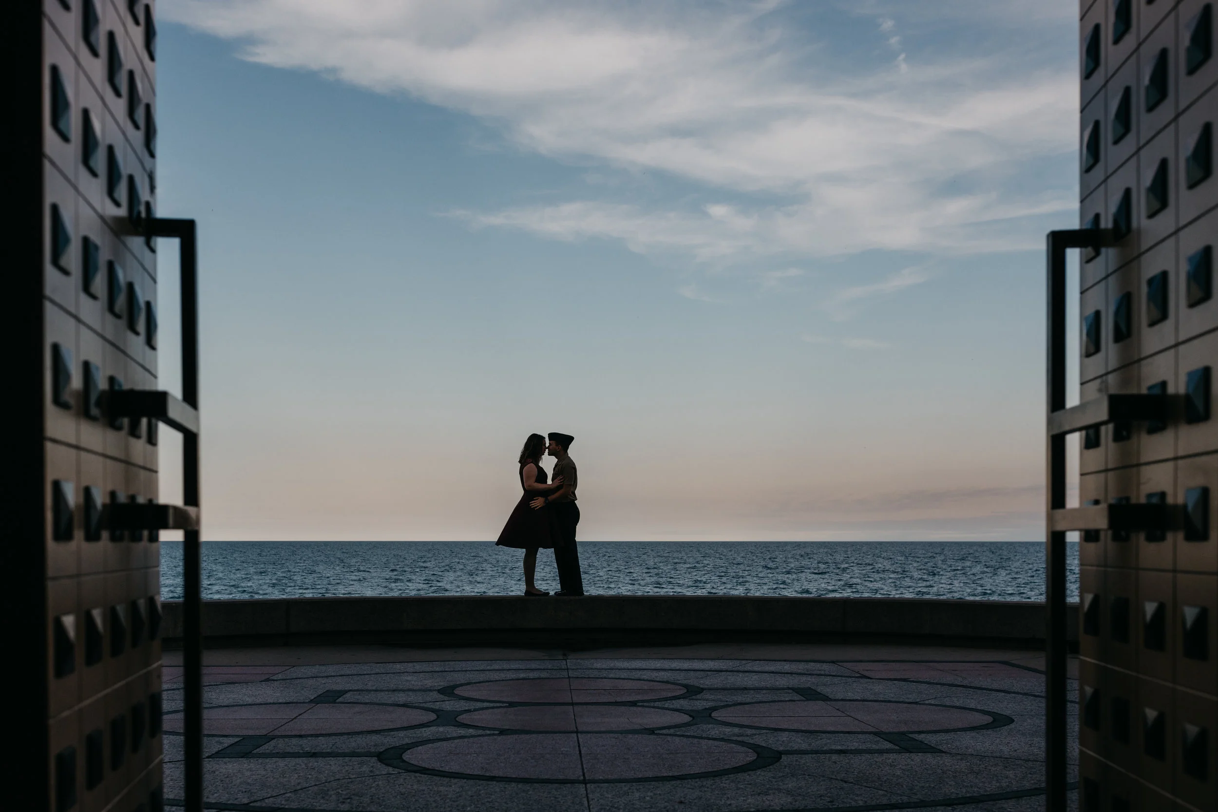 engaged couple kissing near the Madonna Della Strada Chapel
