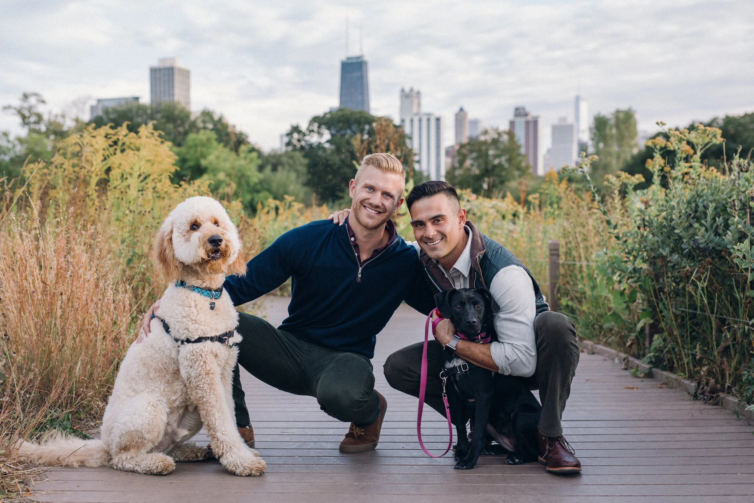 engaged couple posing with their dogs in Chicago’s Lincoln Park