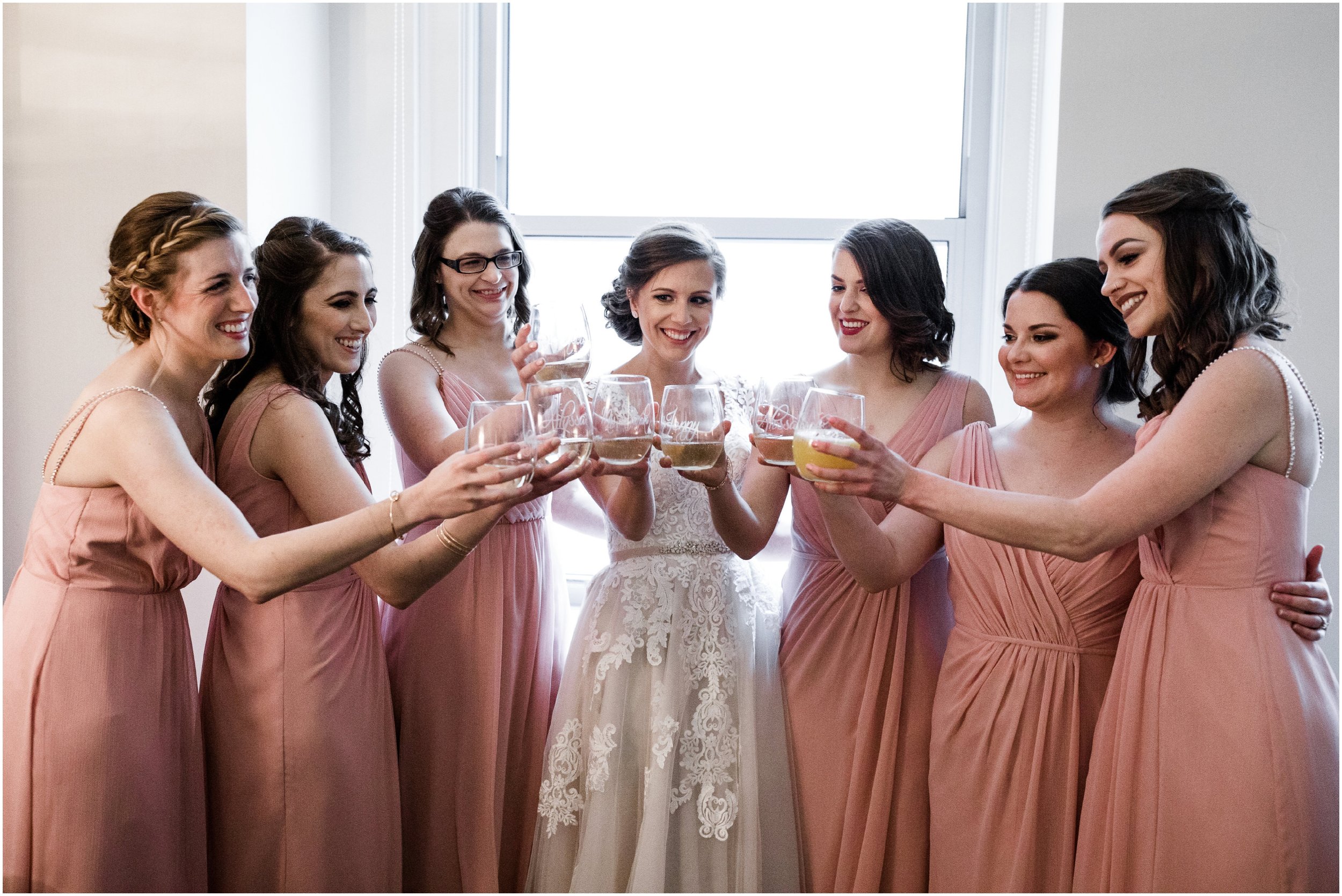 bride and bridesmaids toasting champagne