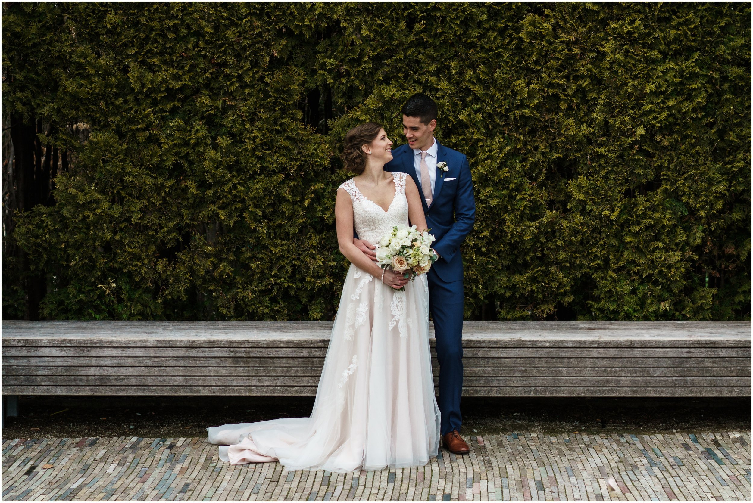 bride and groom posing in Millennium park's Lurie garden