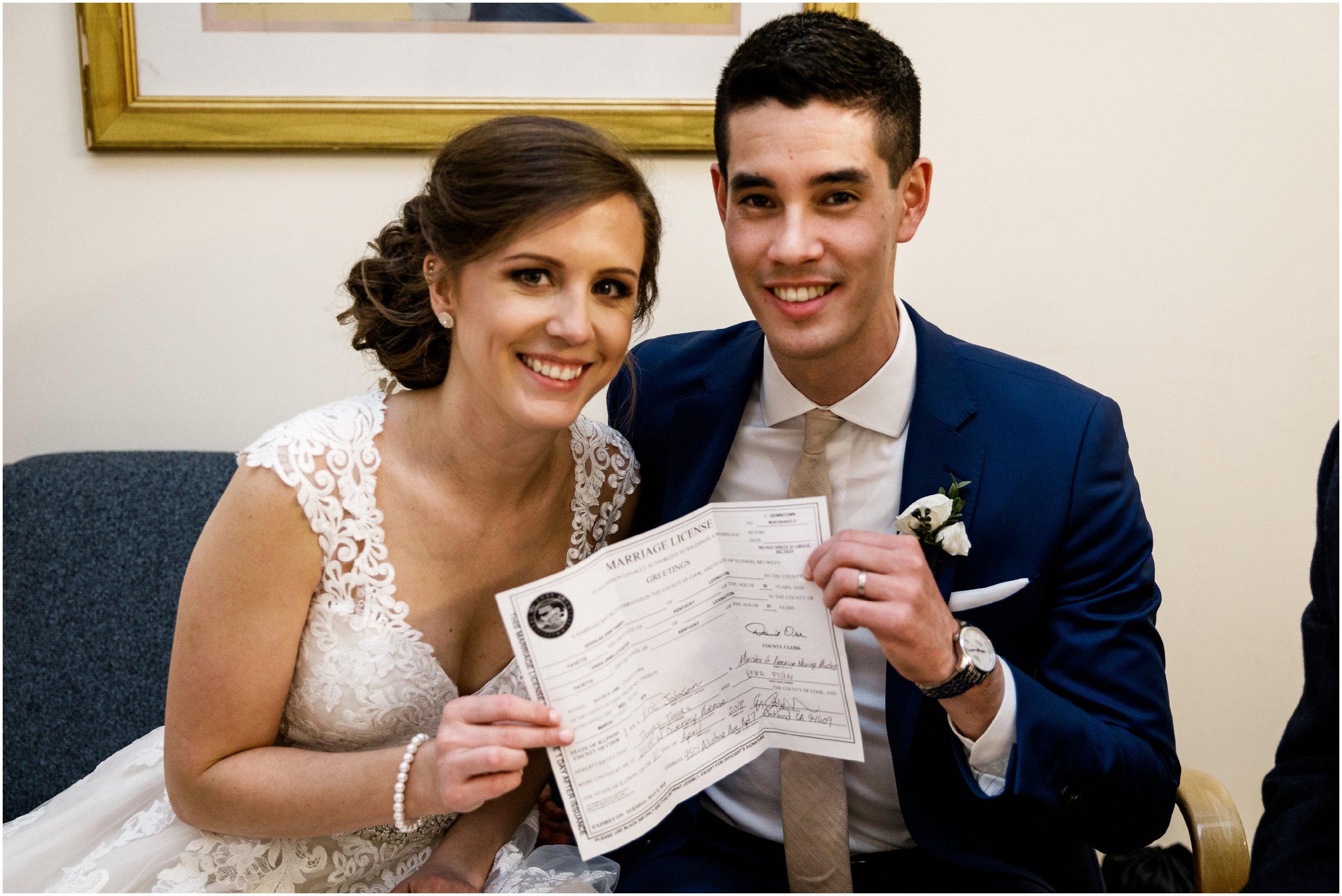  bride and groom holding their marriage license 