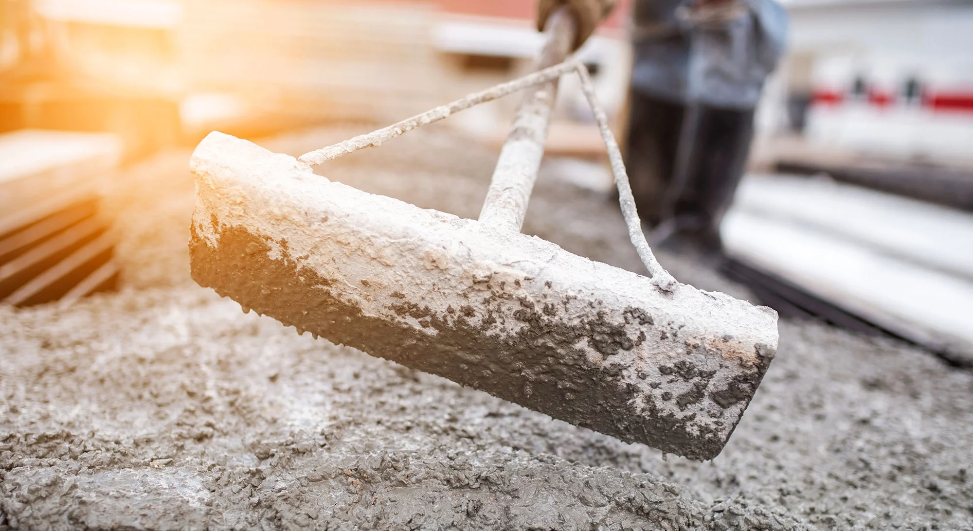 stock-photo-leveling-concrete-with-trowels-laborer-spreading-poured-concrete-selective-focus-a-construction-560978905.jpeg