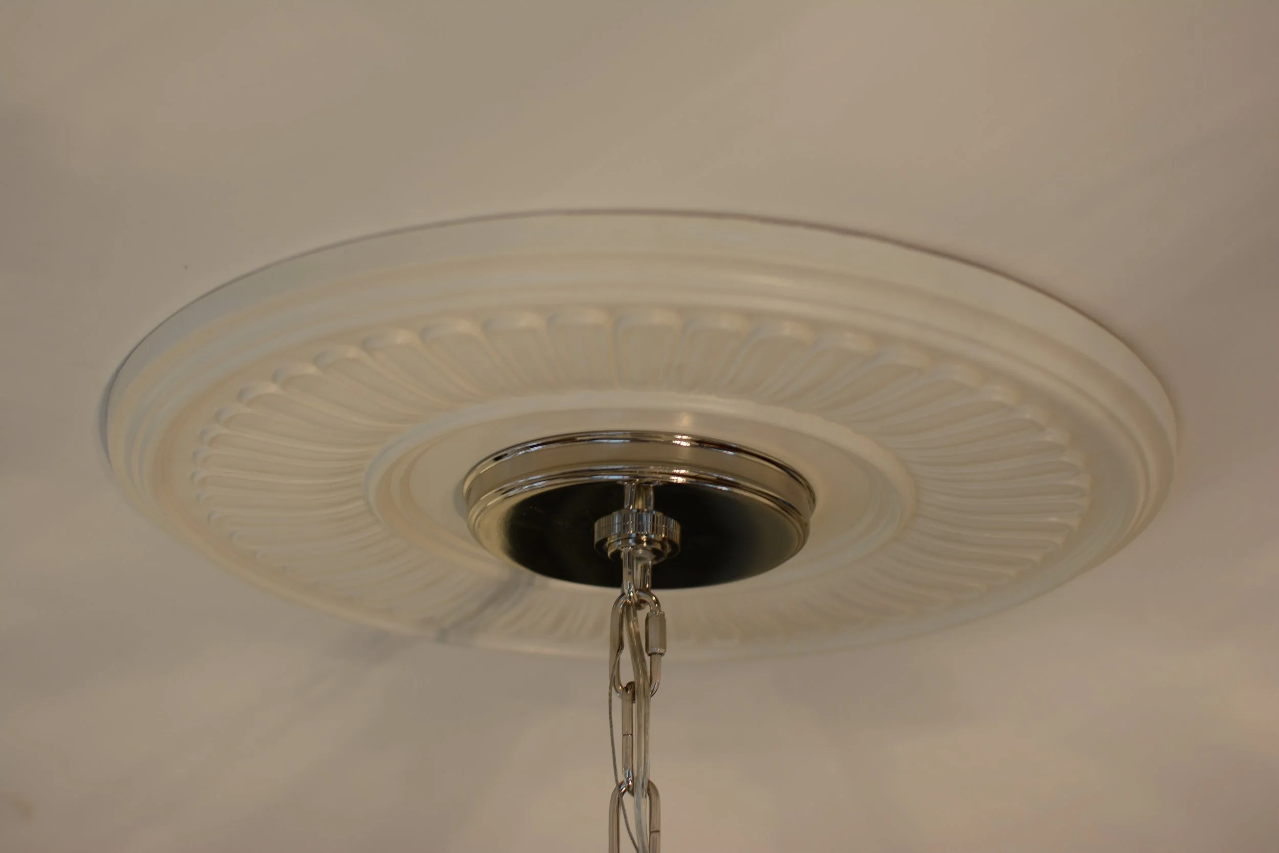 Enhance the impact of the lighting fixture by installing a ceiling medallion