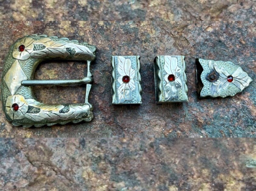 1940s Sterling and 10k Gold w/ Rubies Complete Ranger Western Set

Very nice 1940&rsquo;s vintage silver and gold western buckle set. Hand rocker etched details with little rubies in the cactus blossoms. Nice to find with the keepers and tips intact.