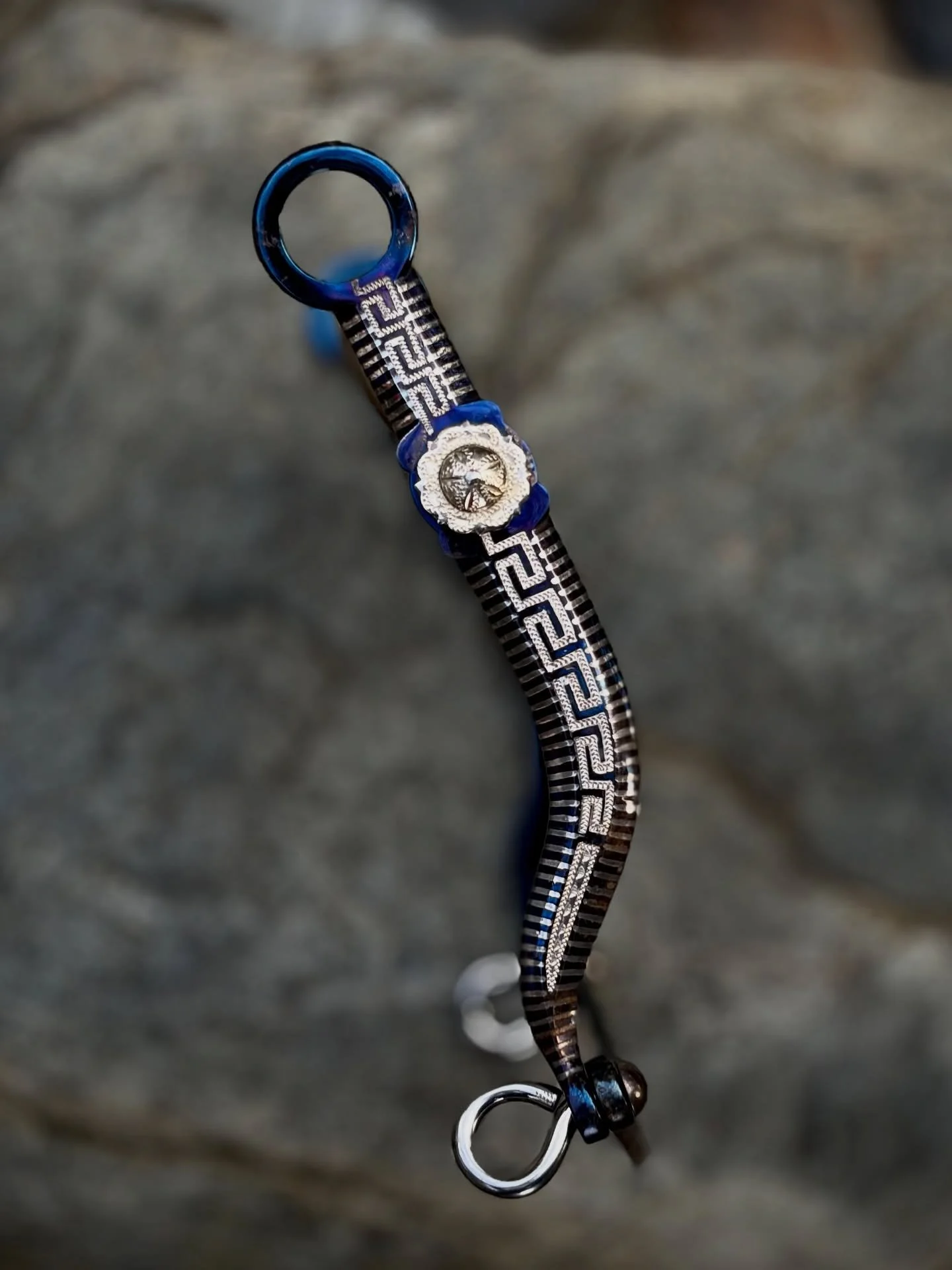 Really nice vintage Greek Key cheek bit with exceptional sterling silver inlay and engraving by the late Frank Rocha.  The cheeks have blued iron and have a nice amount of movement. 5 1/8&rdquo; wide Salinas mouthpiece with copper covered hood and ni