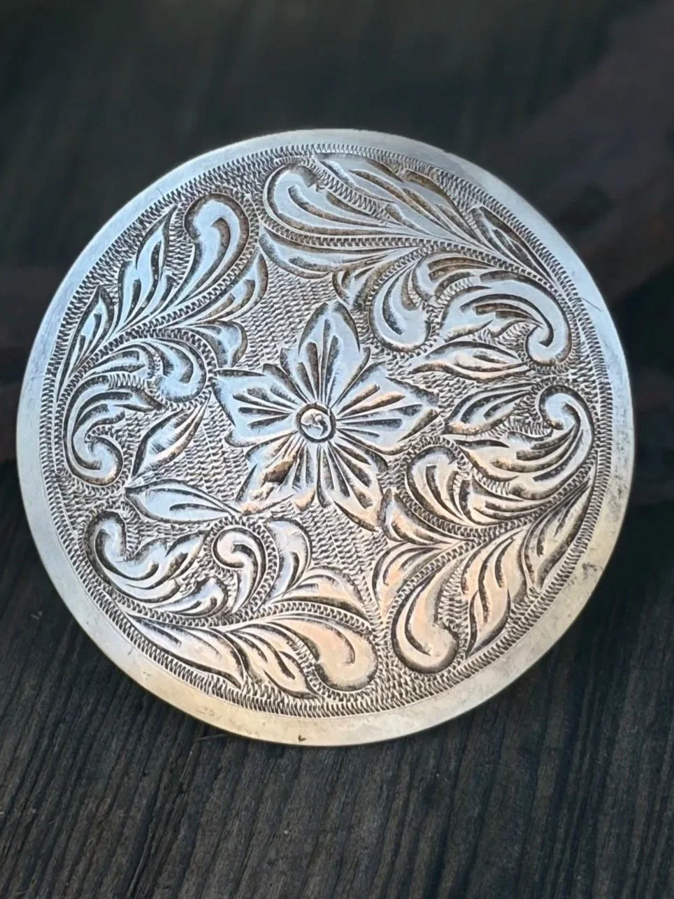 Vintage Hand Engraved Sterling Silver Saddle Horn Cap/Cantle Concho
Available here: https://theoldspanishtrading.com/silver-buckles-and-conchos/silver-horn-cap 

Vintage 1960s finely engraved sterling silver horn cap featuring a 5-petal flower center