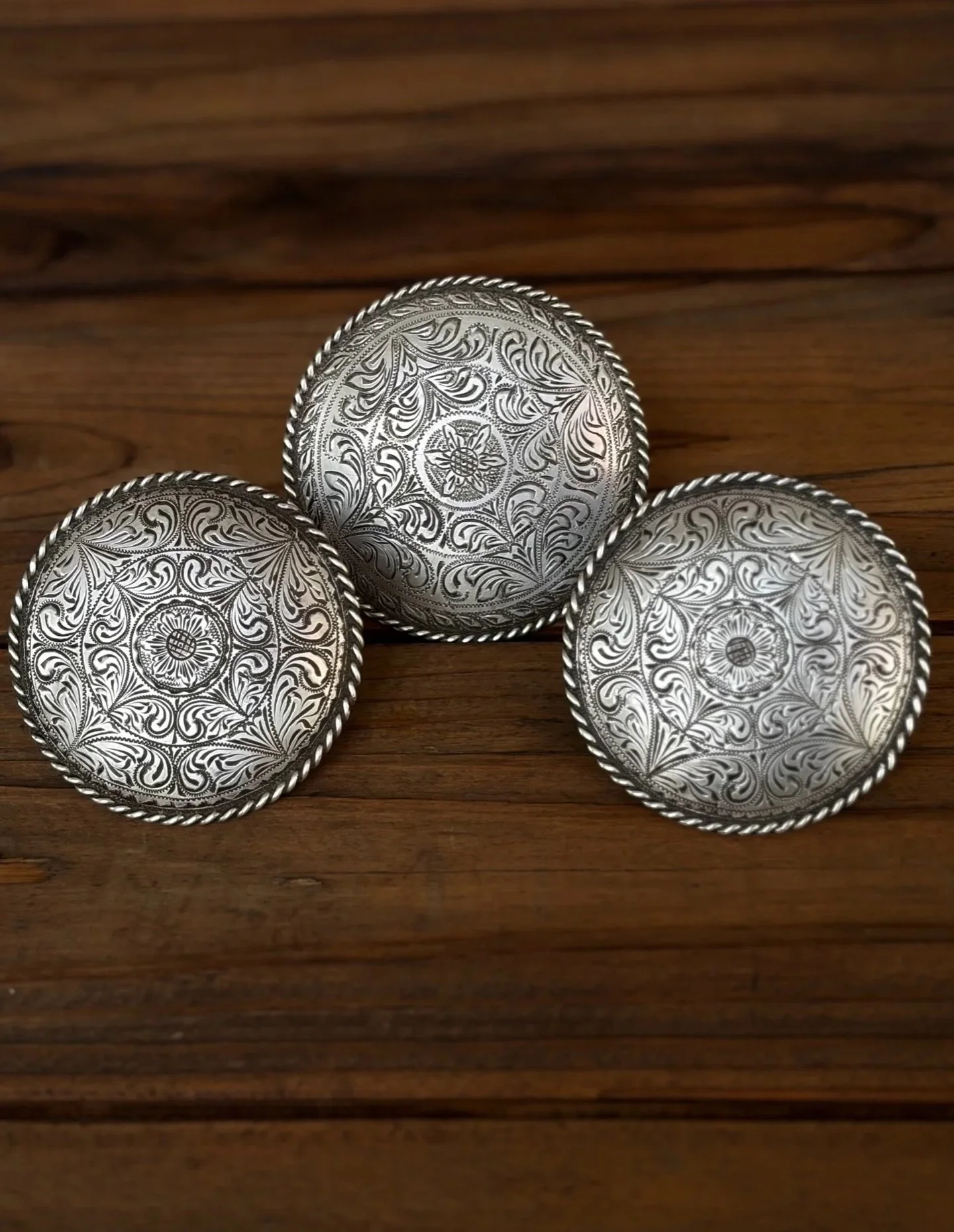 Vintage 1960s finely engraved sterling silver horn caps/cantle conchos featuring flower center motif and floral scroll engraving with sterling silver rope edge. All are made by the late Frank Rocha of Los Angeles, California and come from an archival
