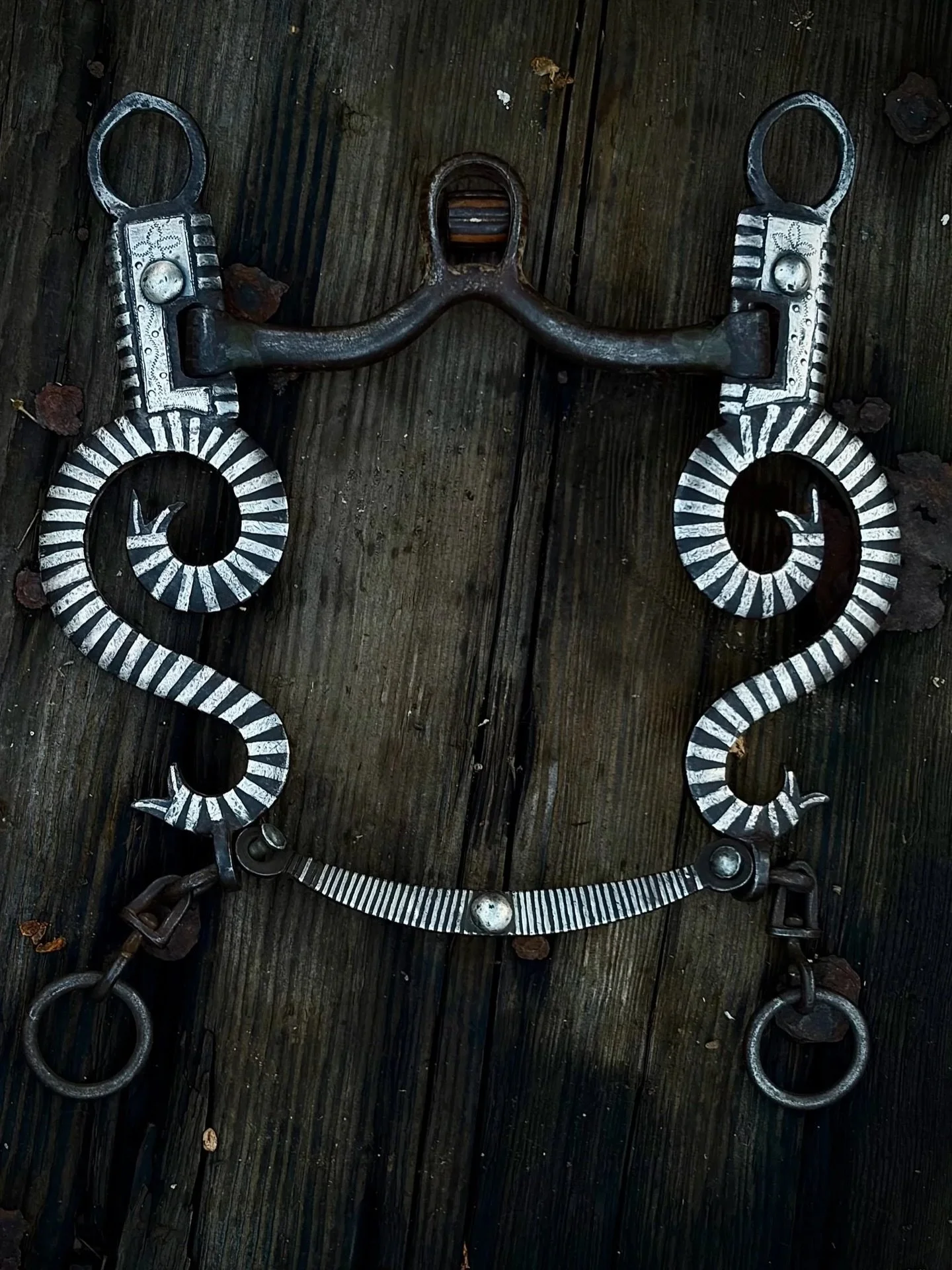 Spectacular Silver inlaid cow horse snake bit by Felix Guitron Sr.  Here is a rare opportunity to own a bit with some incredible history from one of the most important reined cowhorse dynasties. This silver snake bridle bit is by the late Felix Guitr