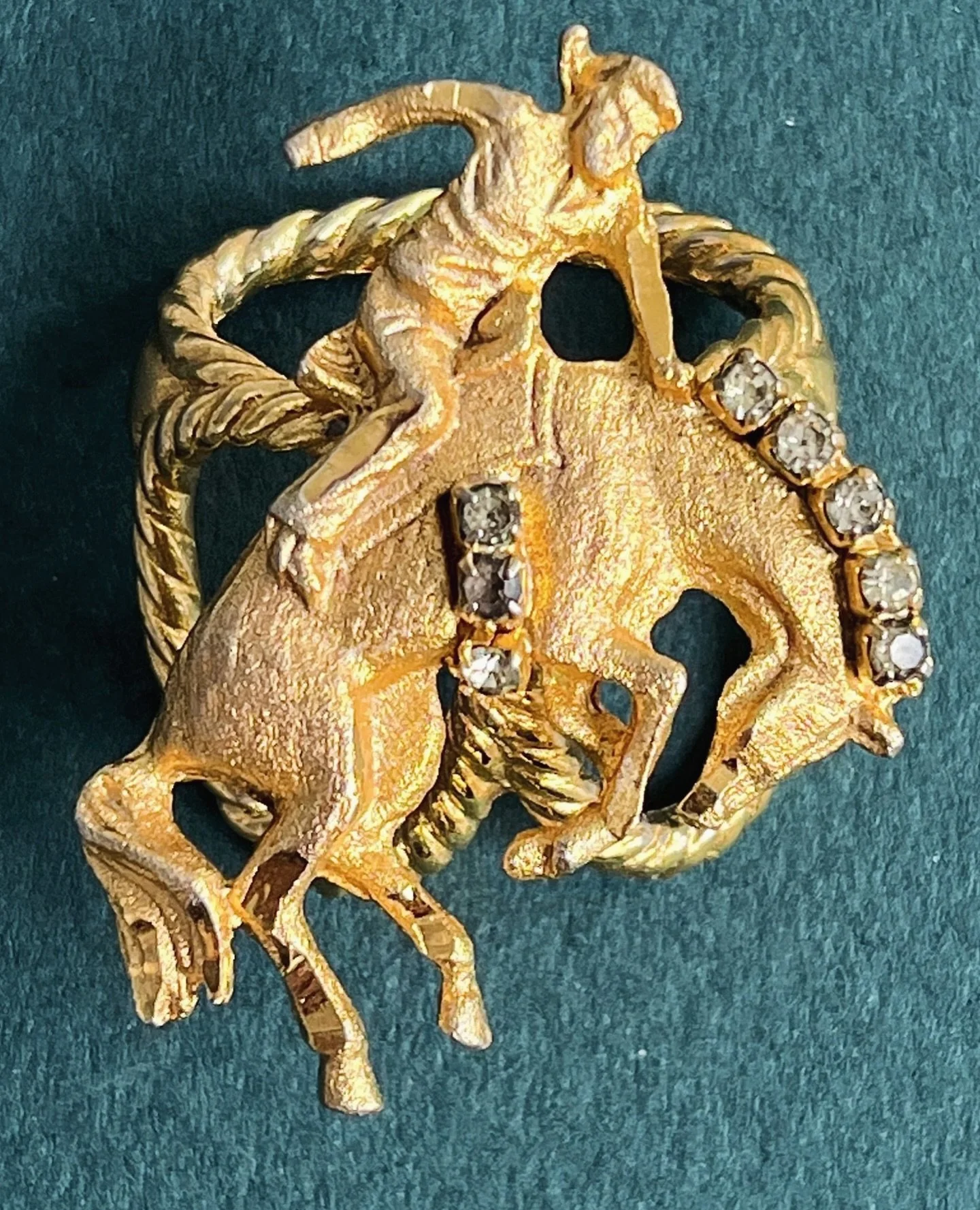 ✨ Vintage Saddle Bronc Western Scarf Slide ✨
Available here: https://theoldspanishtrading.com/pins-fobs/bronc-slide 

Really neat circa 1950s cowboy and bronc scarf slide. Very nice gold flashed finish accented with rhinestones. This is a very neat c