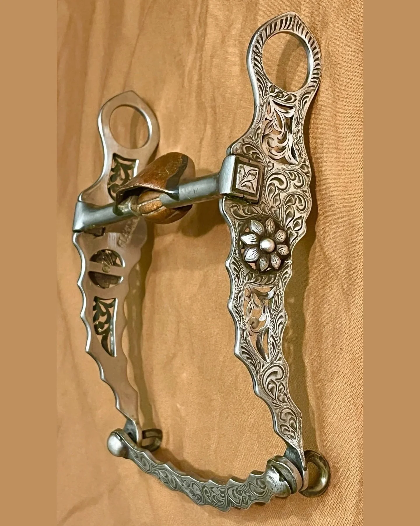 Very nice, useable, silver filagreed cactus blossom bit by Fleming
Available here: https://theoldspanishtrading.com/bits/fleming-bit 

Maker stamped inside of cheek. Full sterling silver inlay and a Salinas mouthpiece with copper hood and roller. Thi