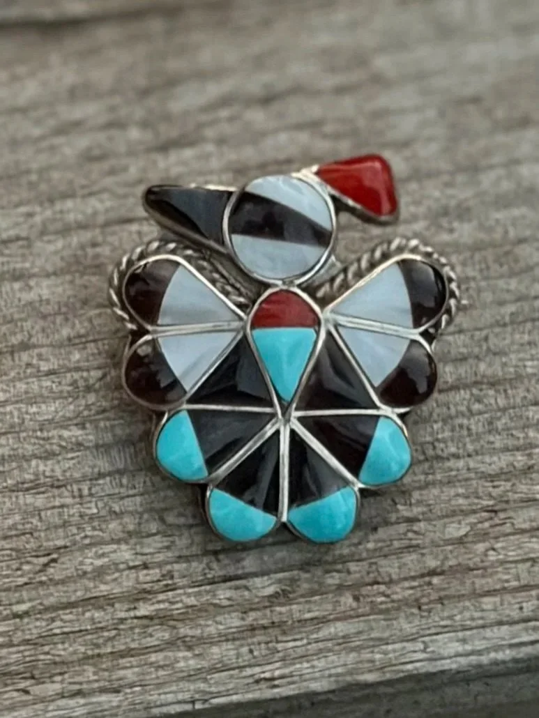 Vintage Zuni Woodpecker pendant/hat pin with sterling silver and inlay of turquoise, onyx, coral, and mother of pearl
Available here: https://theoldspanishtrading.com/pins-fobs/woodpecker-zuni-pin 

Vintage Zuni Woodpecker pendant/hat pin with sterli