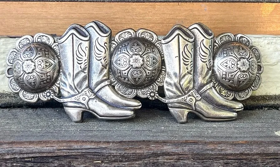 ✨ 1940s Silver Concho and Cowboy Boot Hair Barrette ✨
Available here: https://theoldspanishtrading.com/pins-fobs/concho-barrette 

1940&rsquo;s Silver Concho and Cowboy Boots Hair Barrette.  Beautiful and one of a kind.  I&rsquo;ve never come across 