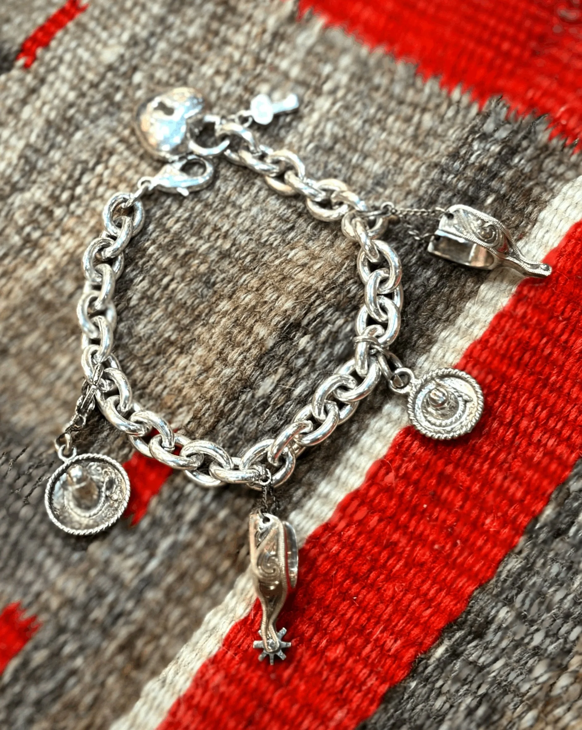 ✨ Vintage sterling silver cowboy charm bracelet ✨ 
Available here: https://theoldspanishtrading.com/silver-buckles-and-conchos/cowboy-charm-bracelet 

Beautiful vintage sterling silver solid link charm bracelet with the cutest vintage sterling cowboy