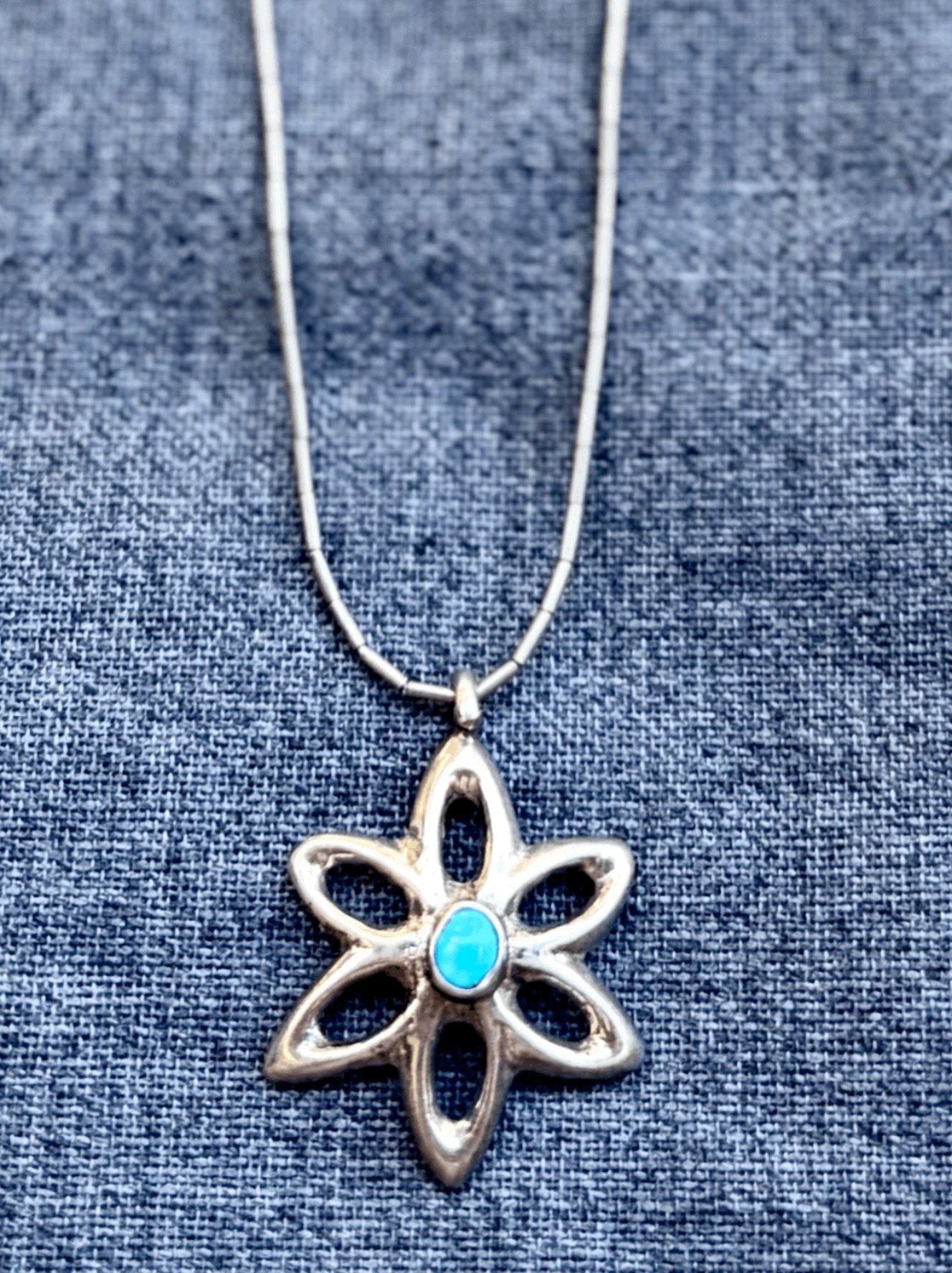 ✨ Vintage Navajo sandcast sterling and turquoise flower pendant necklace ✨ 
Available here: https://theoldspanishtrading.com/silver-buckles-and-conchos/vintage-navajo-sandcast-sterling-and-turquoise-flower-pendant-necklace 

Beautiful vintage Navajo 