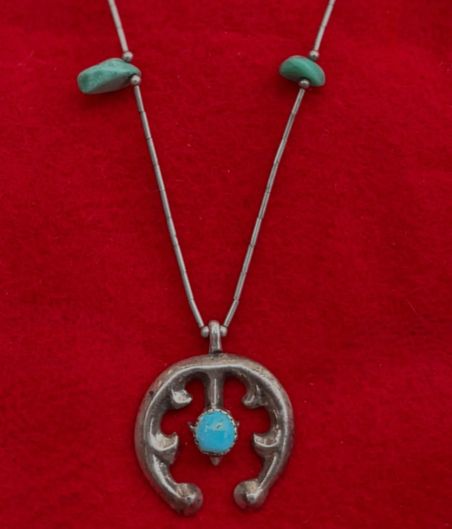 Vintage Navajo sandcast sterling silver Naja and turquoise pendant necklace
Available here: https://theoldspanishtrading.com/silver-buckles-and-conchos/vintage-navajo-sandcast-sterling-silver-naja-and-turquoise-pendant-necklace 

Beautiful vintage Na