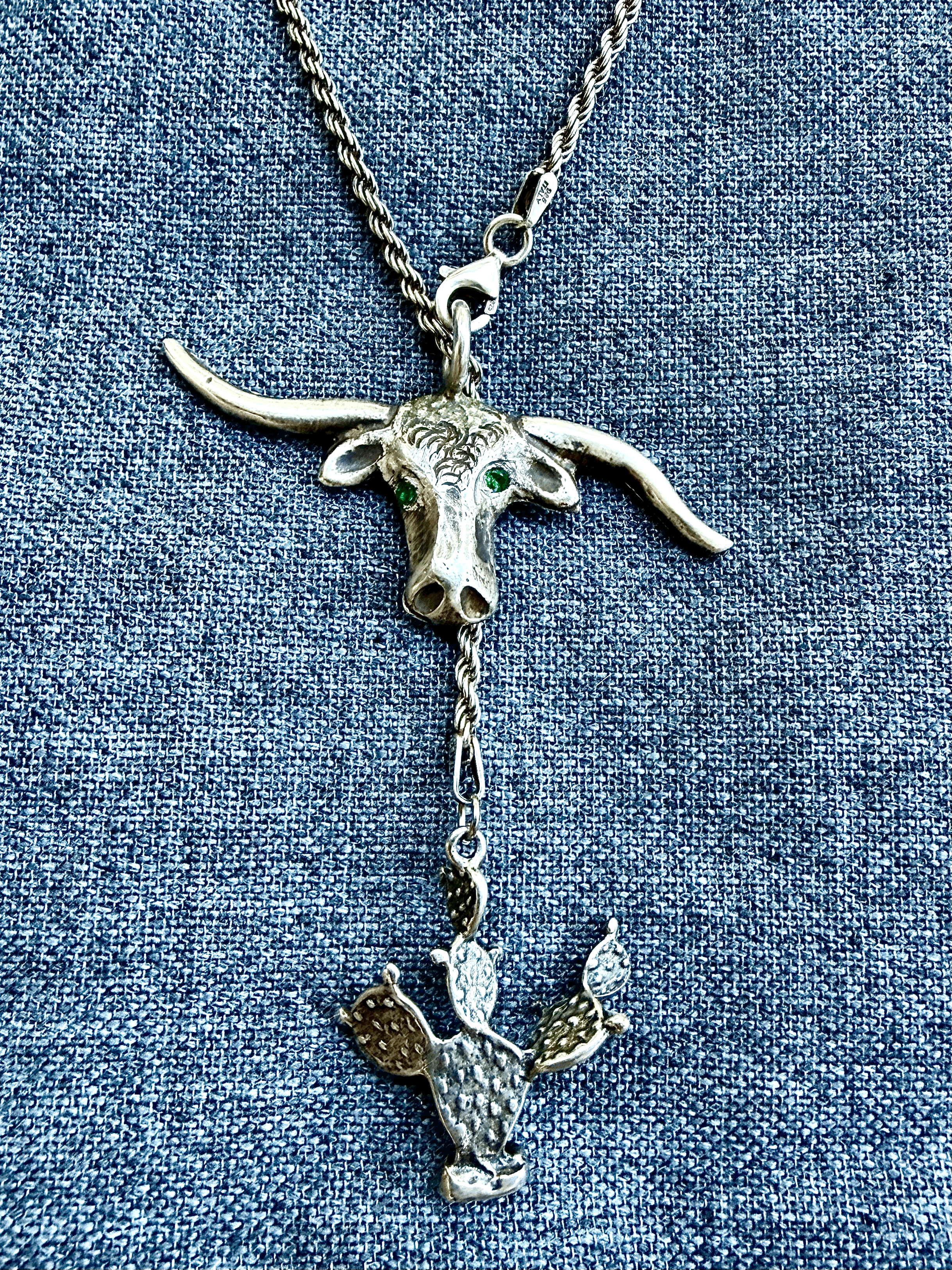 Antique sterling lariat necklace with longhorn w emerald eyes and prickly pear cactus charm