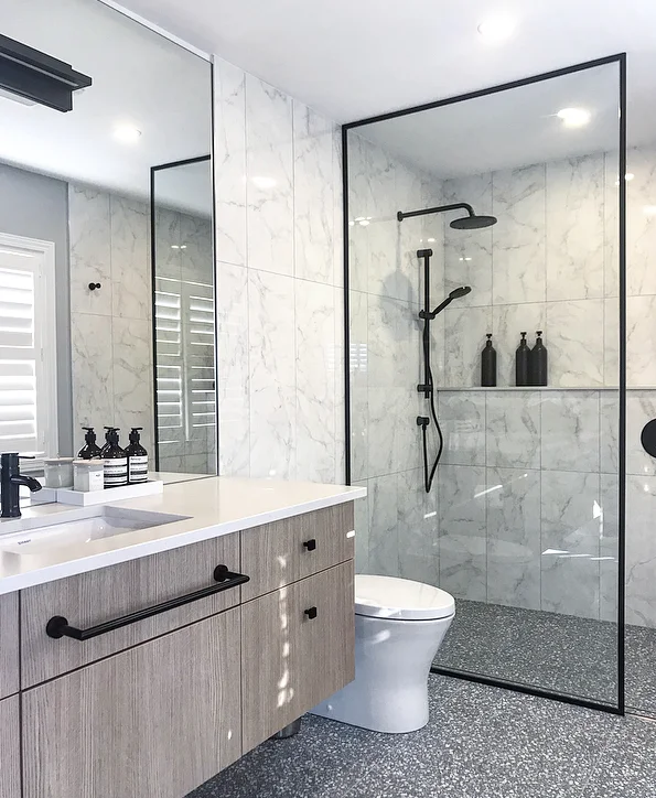 Millwork: Miralis custom millwork, supplied and installed via Astro Design Centre. Countertop: Caesarstone 4001 Fresh Concrete. Faucet: Alt by Aquabrass in Electro Black. Light: Matteo Lighting.