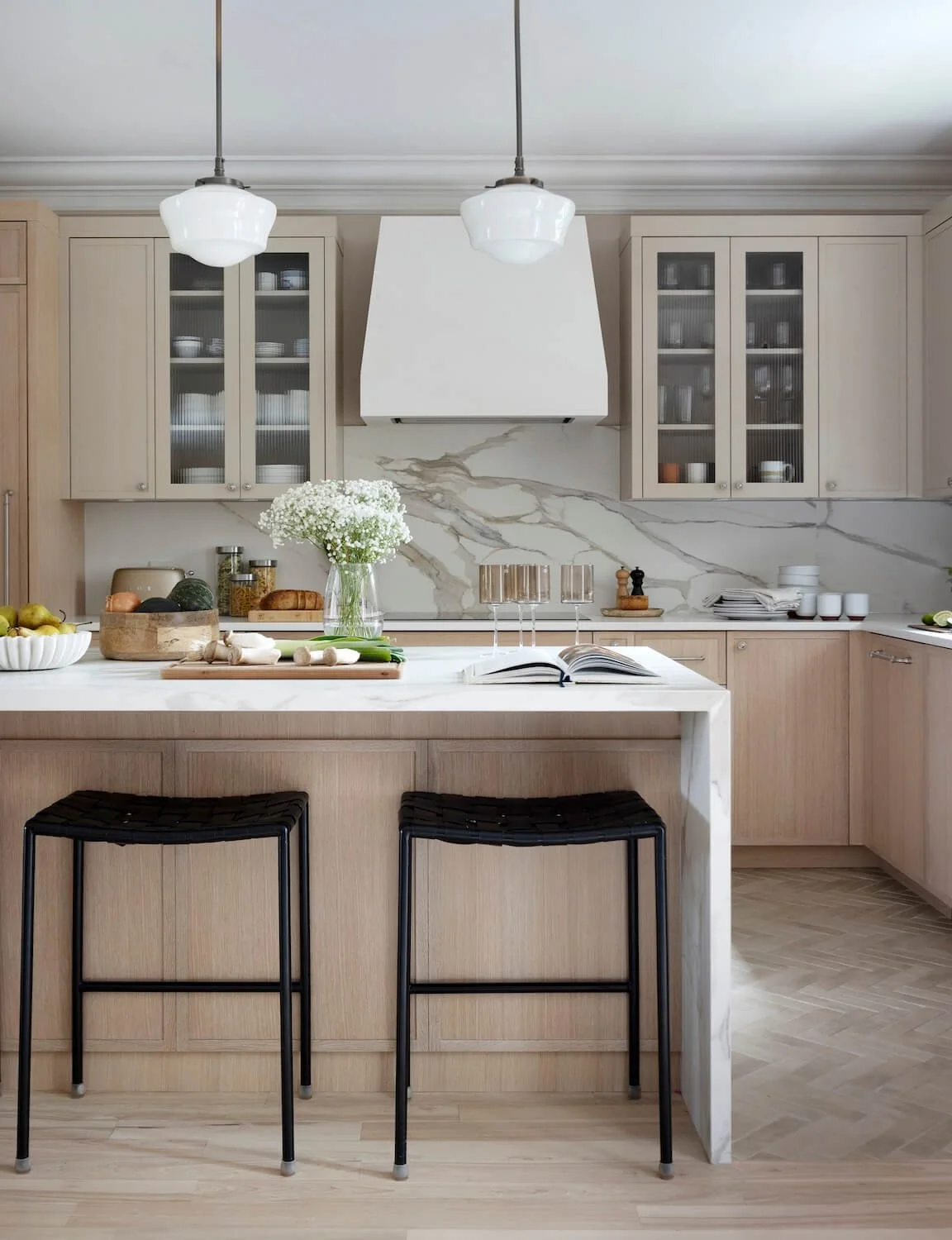 Wood and taupe kitchen with plaster hood vent and porcelain countertops.