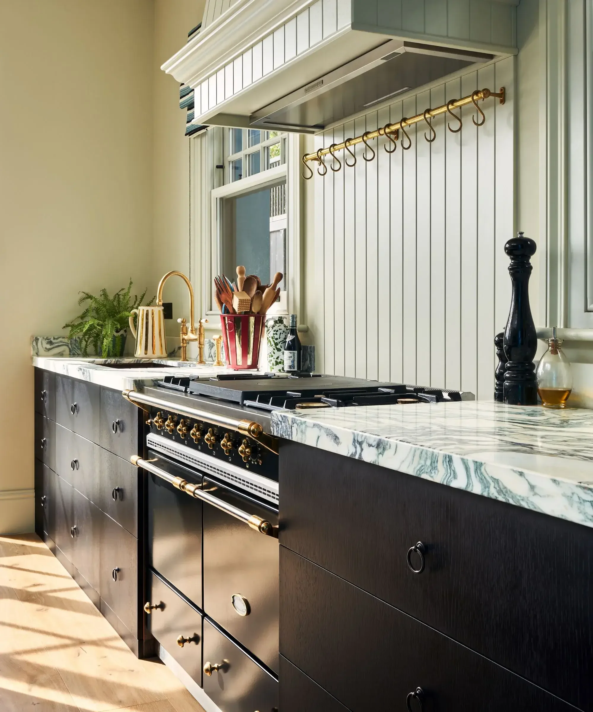 Inspiration image of a kitchen with dark wood cabinets and marble countertops, design by Pringle & Pringle.
