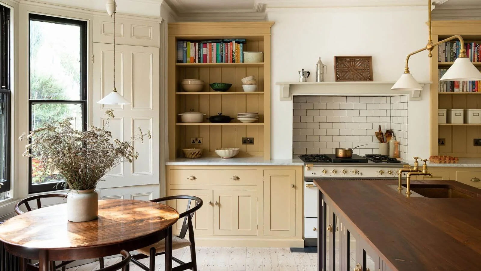 Traditional kitchen with buttery-yellow inset cabinetry.