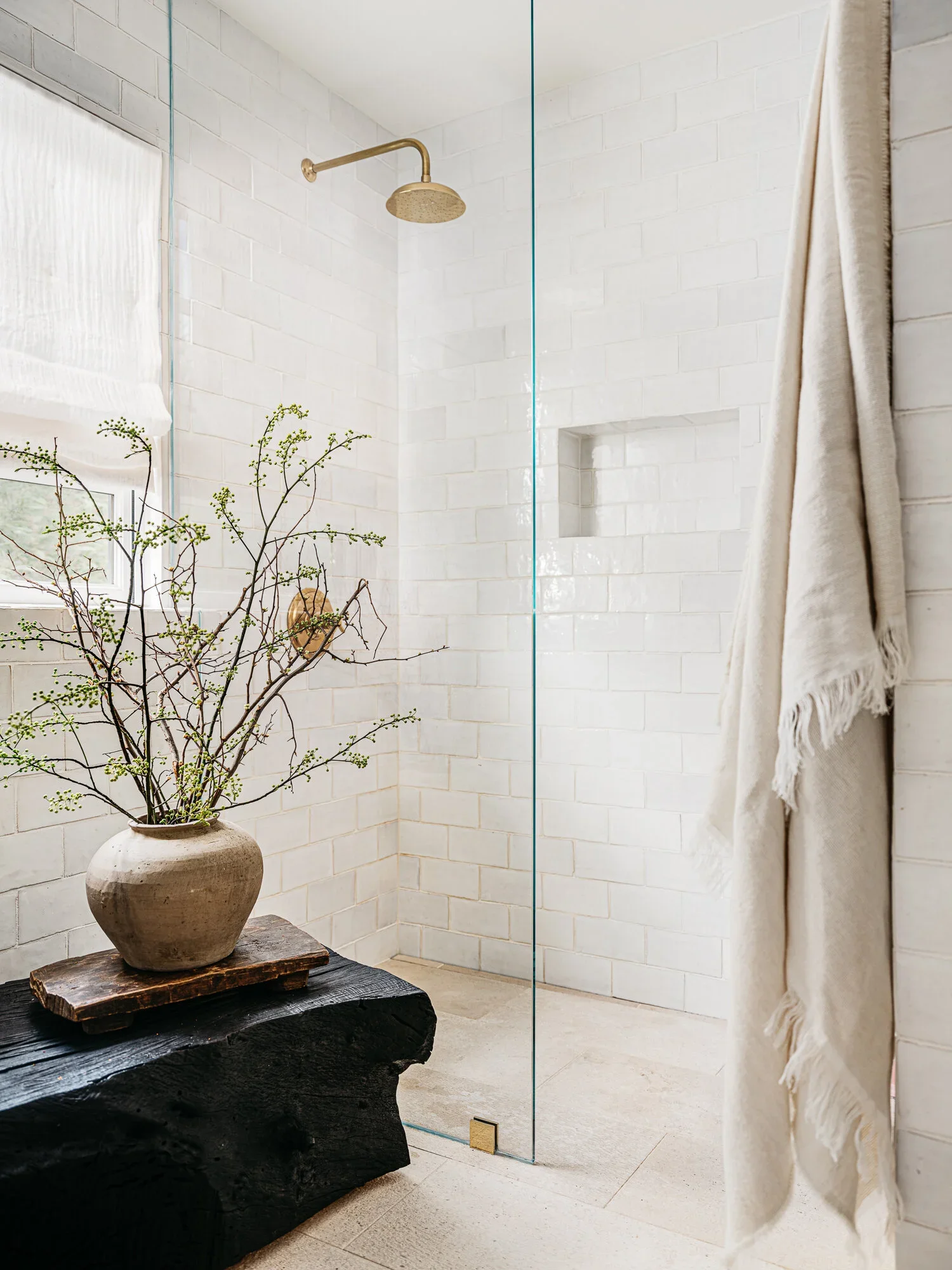 Inspiration image of an open custom shower with textured subway tile, design by Lindsay Gerber