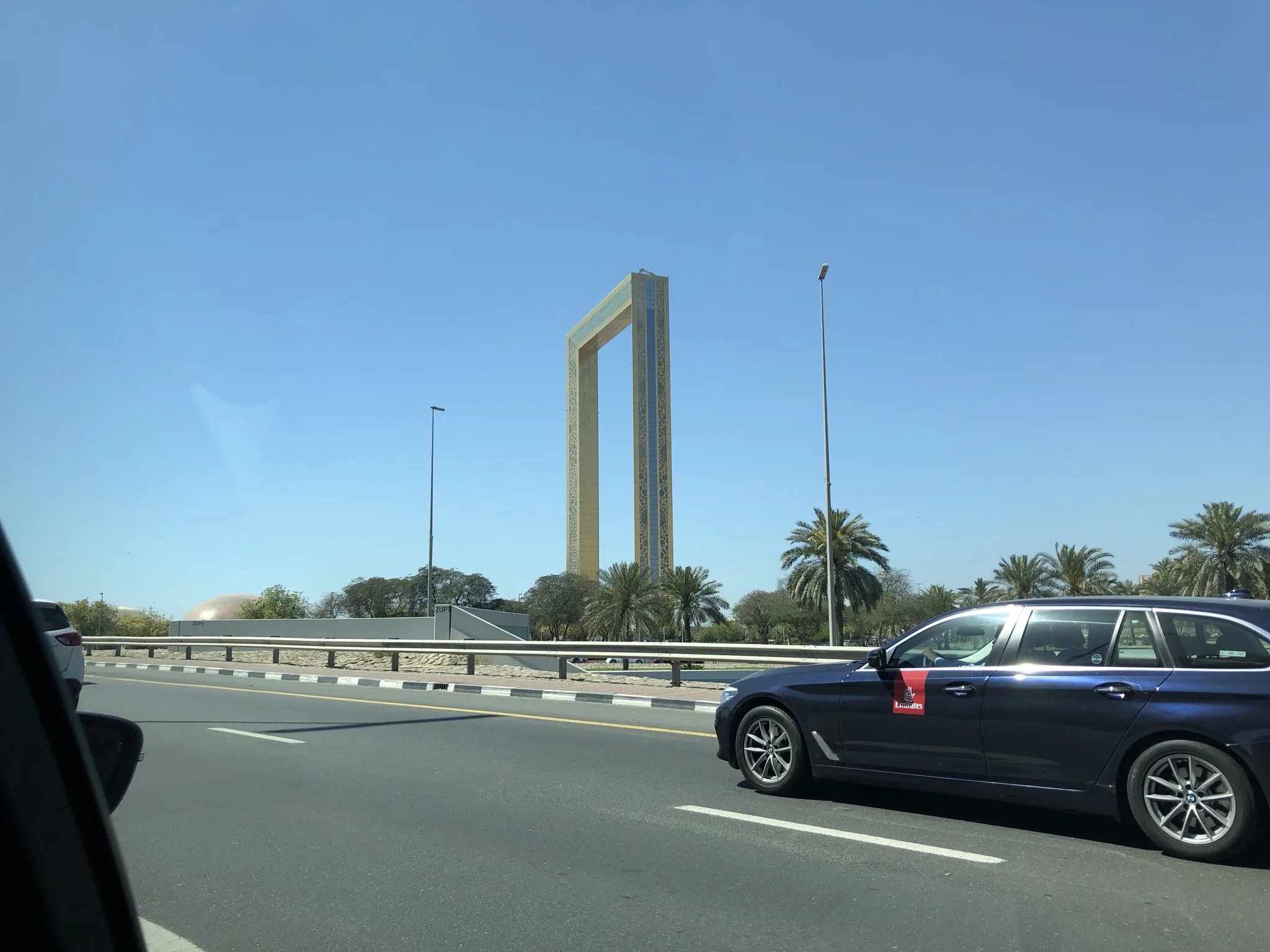 Passing by the Frame, newest attraction in Dubai, and another EK chauffeur service car