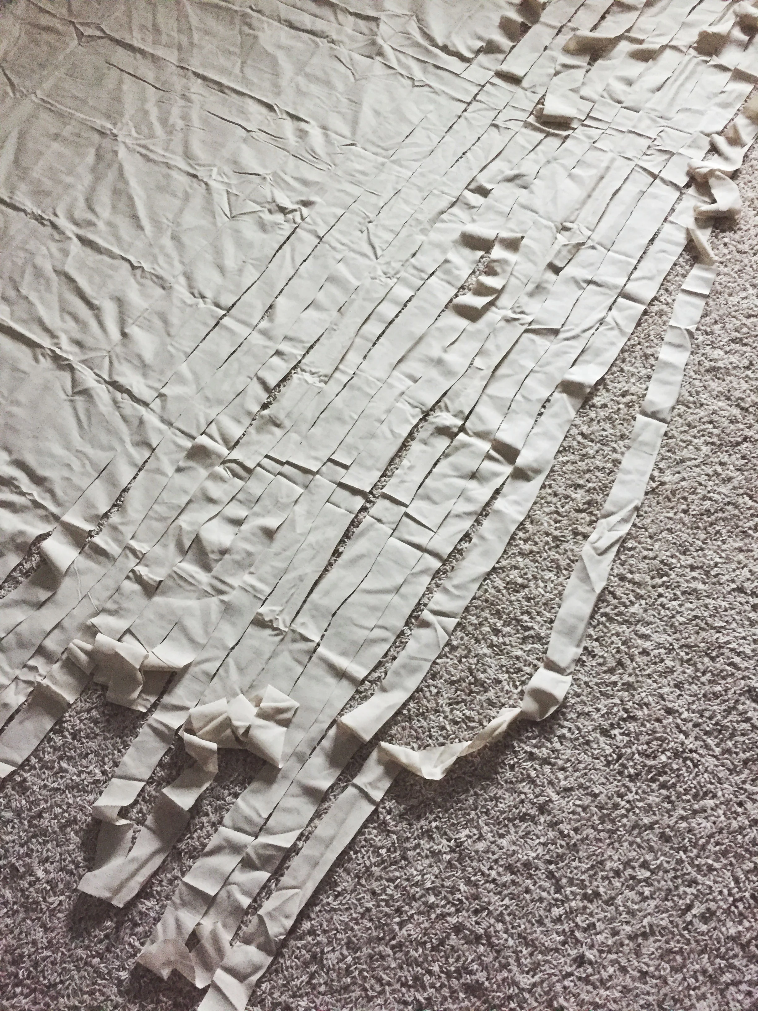 My living room floor, mid-sheet yarn cutting.
