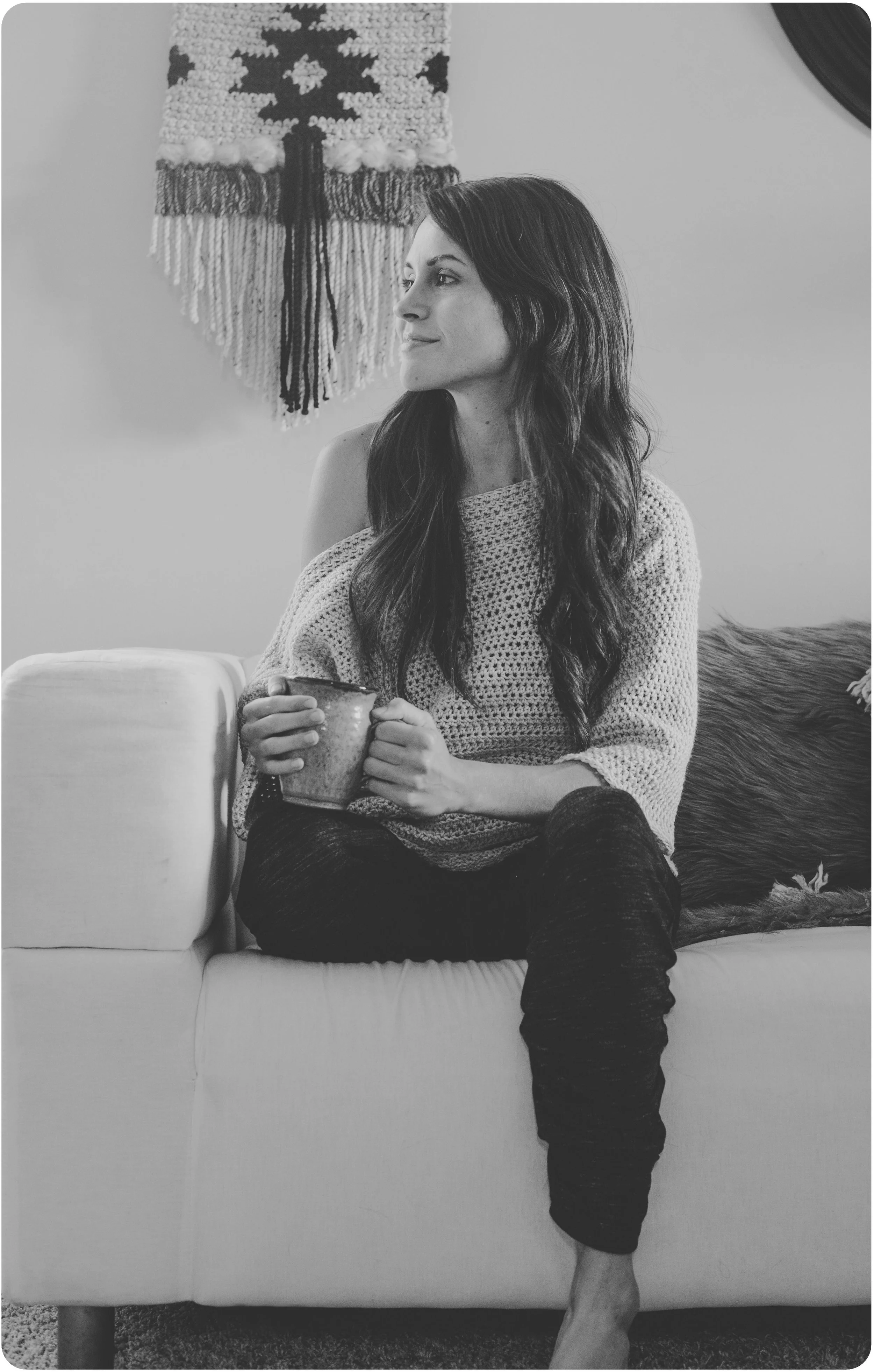 A photo of the Homebody Sweater in it's natural habitat: my home. haha In this photo, I'm setting the scene of how someone might enjoy their own sweater-- on the couch with a cup of coffee with a cozy blanket nearby. Can't forget the fun little Aztec Wall Hanging in the back!