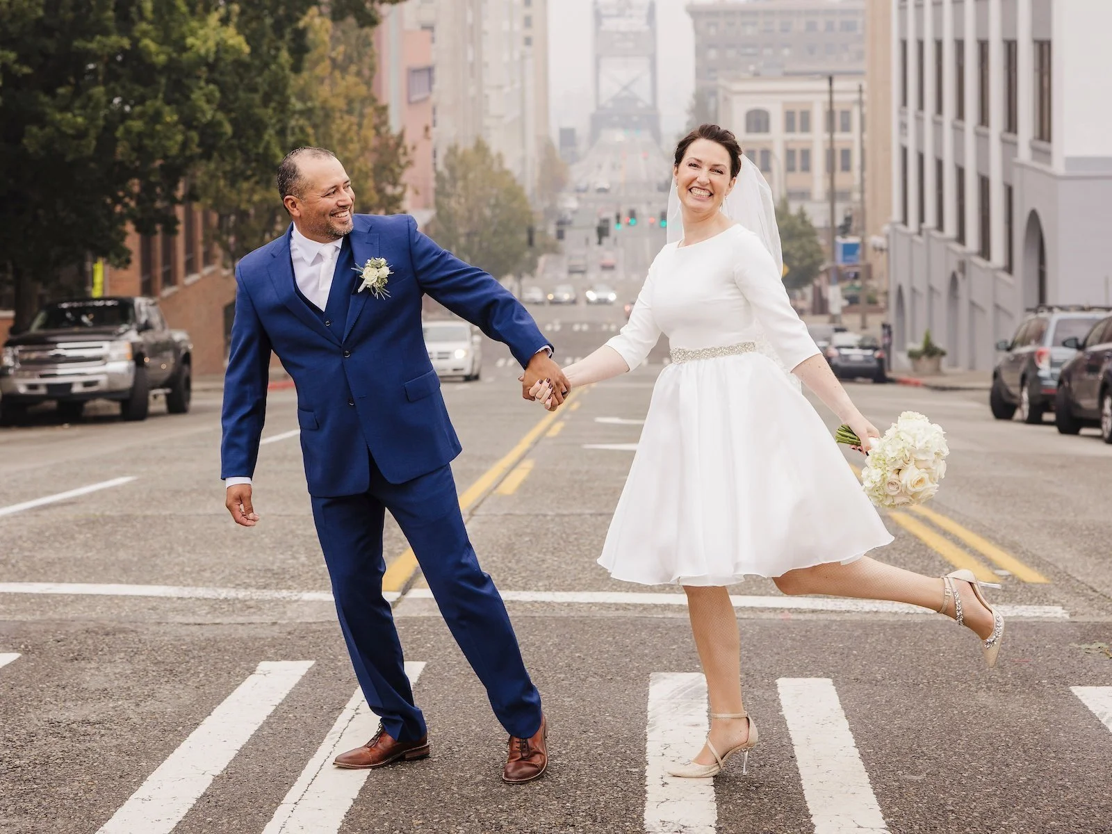 A couple eloping in Tacoma and walking in front of the 11th Street bridge for photos