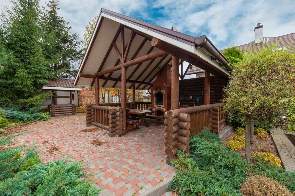 Brick paver patio with a covered wooden gazebo