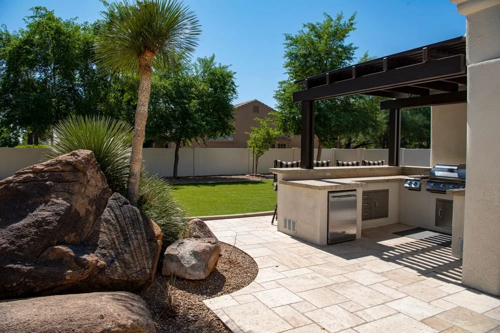 Concrete paver patio with an outdoor kitchen