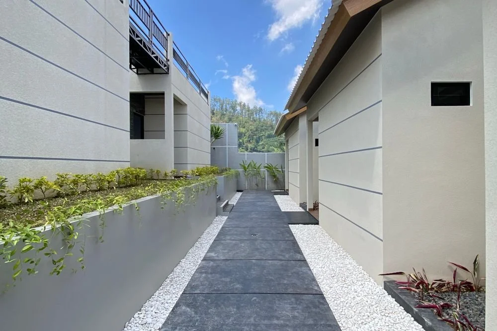 Modern concrete walkway bordered by white gravel